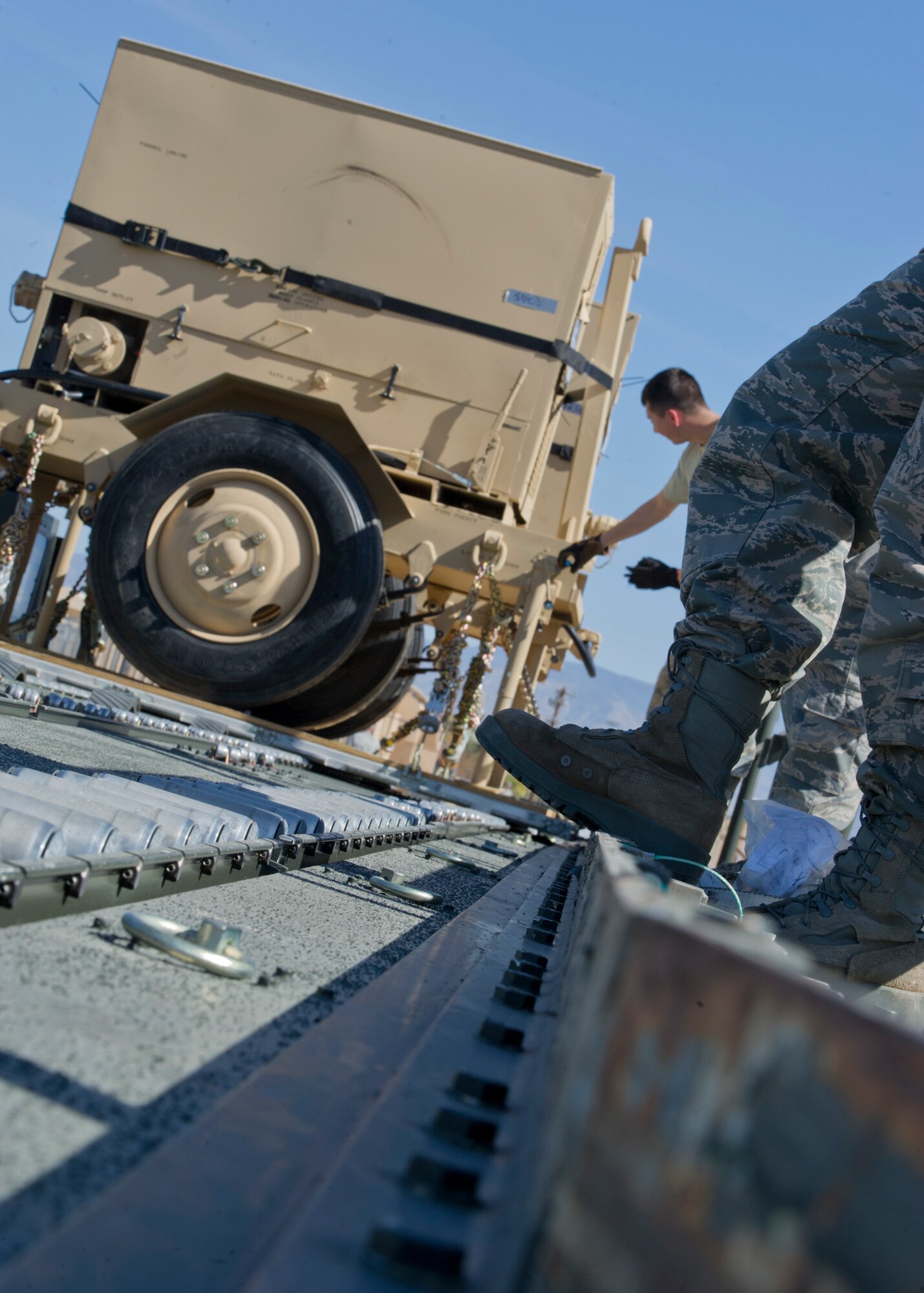 Personnel of the 49th Materiel Maintenance Squadron, load a pallet onto a 60,000-pound K-Loader at Holloman Air Force Base, N.M., Nov. 2. The 49th MMS was tasked with supporting the humanitarian relief efforts for the victims of Hurricane Sandy. In response to the tasking, the 49th MMS worked for 15 straight hours preparing more than 58,000 pounds of cargo spread across eight pallets. The cargo consisted of two water pumps capable of pumping 400 gallons of water a minute, 12,000 feet of hose, and two containers of system support items. (U.S. Air Force photo by Senior Airman DeAndre Curtiss/Released)