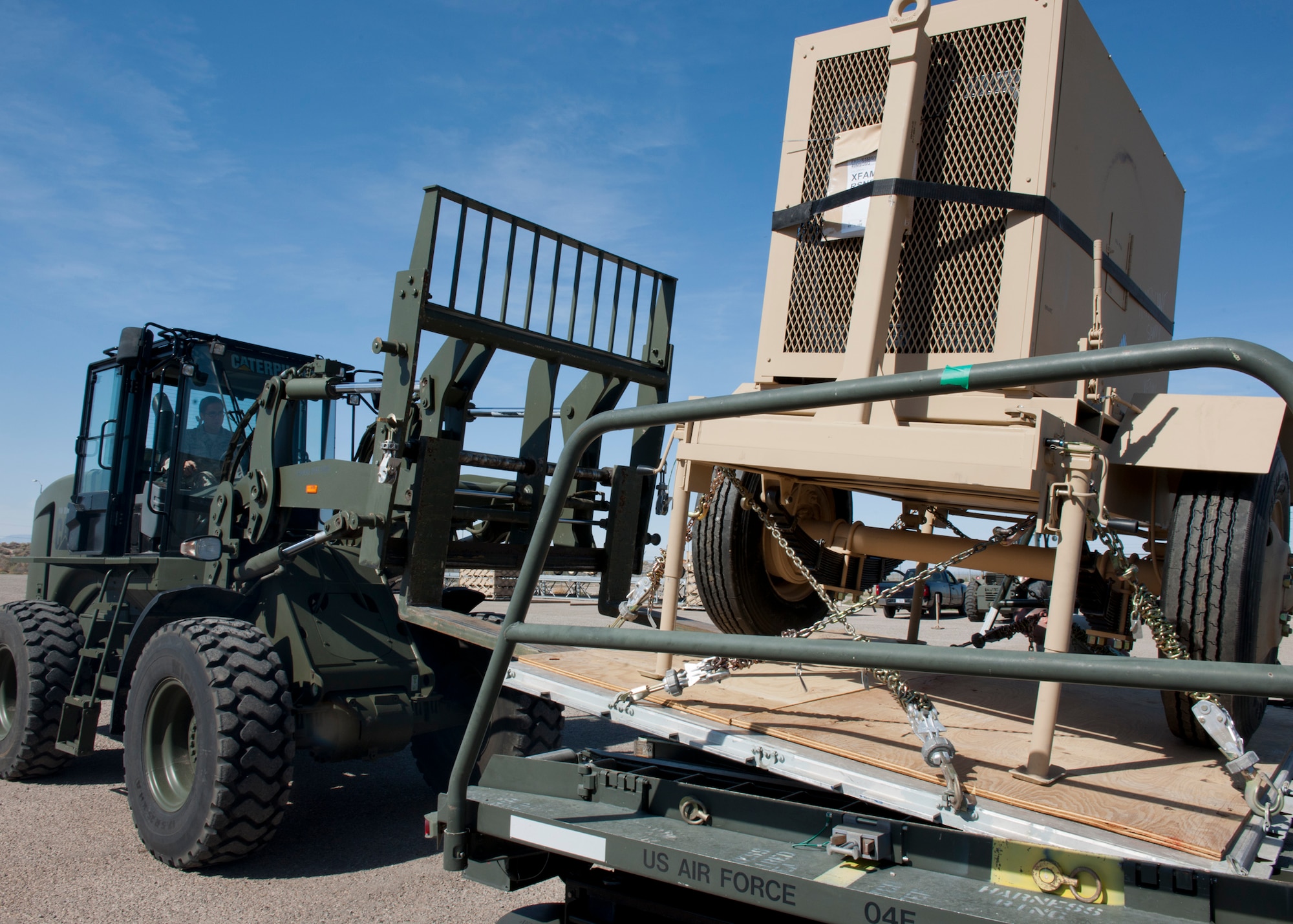 Personnel of the 49th Materiel Maintenance Squadron, load a pallet onto a 60,000-pound K-Loader using a forklift at Holloman Air Force Base, N.M., Nov. 2. The 49th MMS was tasked with supporting the humanitarian relief efforts for the victims of Hurricane Sandy. In response to the tasking, the 49th MMS worked for 15 straight hours preparing more than 58,000 pounds of cargo spread across eight pallets. The cargo consisted of two water pumps capable of pumping 400 gallons of water a minute, 12,000 feet of hose, and two containers of system support items. (U.S. Air Force photo by Senior Airman DeAndre Curtiss/Released)