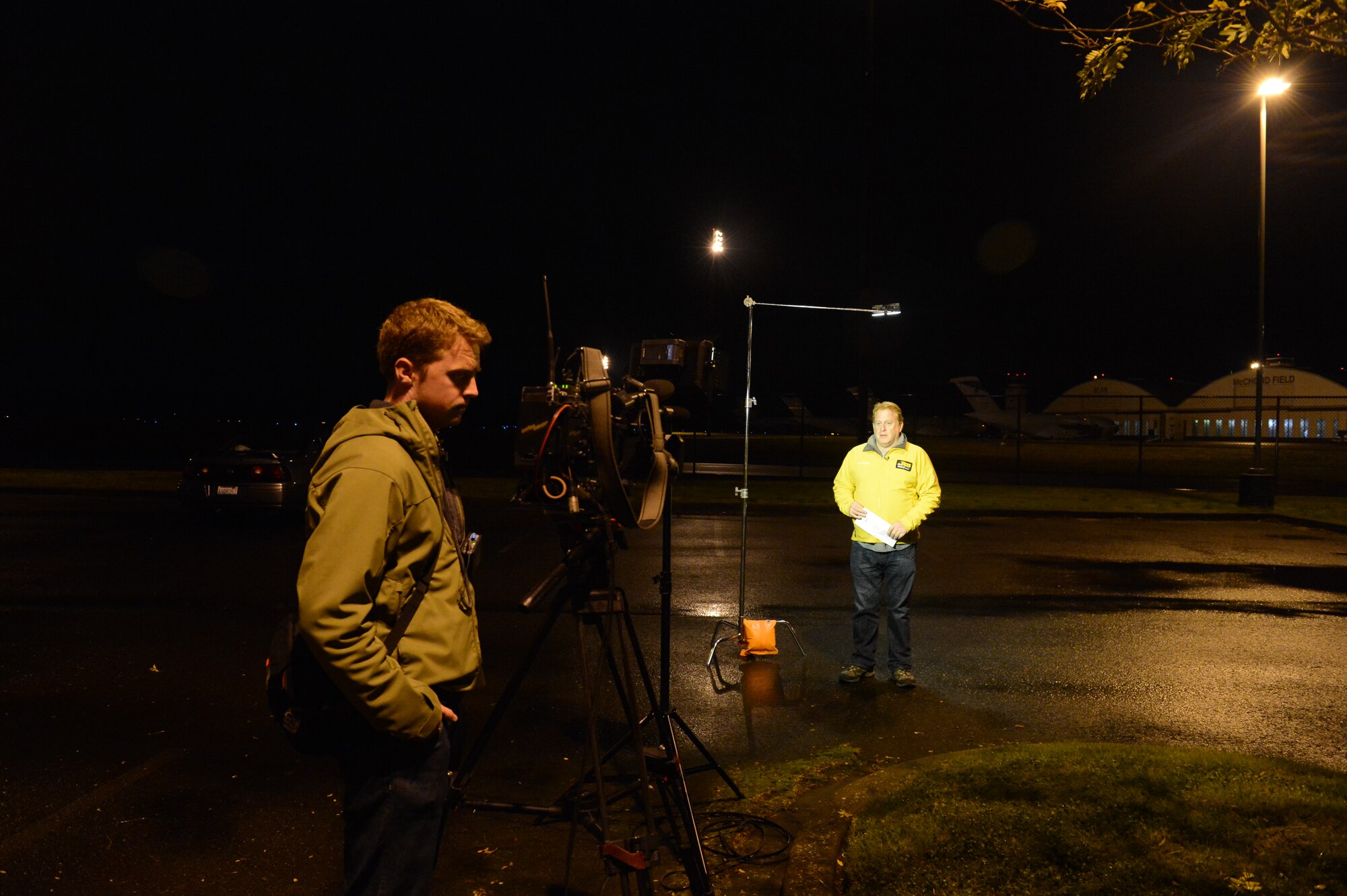 Jim Forman, a correspondent with KING-5 News in Seattle, Wash., broadcasts a live report, Nov. 1, 2012, from Joint Base Lewis-McChord, Wash., to cover McChord Field's involvement in Hurricane Sandy relief efforts. C-17 Globemaster III aircraft from McChord Field deployed to Stewart Air National Guard Base, N.Y., to deliver electrical utility vehicles to be used to restore power in the areas affected by the hurricane. (U.S. Air Force photo/Staff Sgt. Sean Tobin)