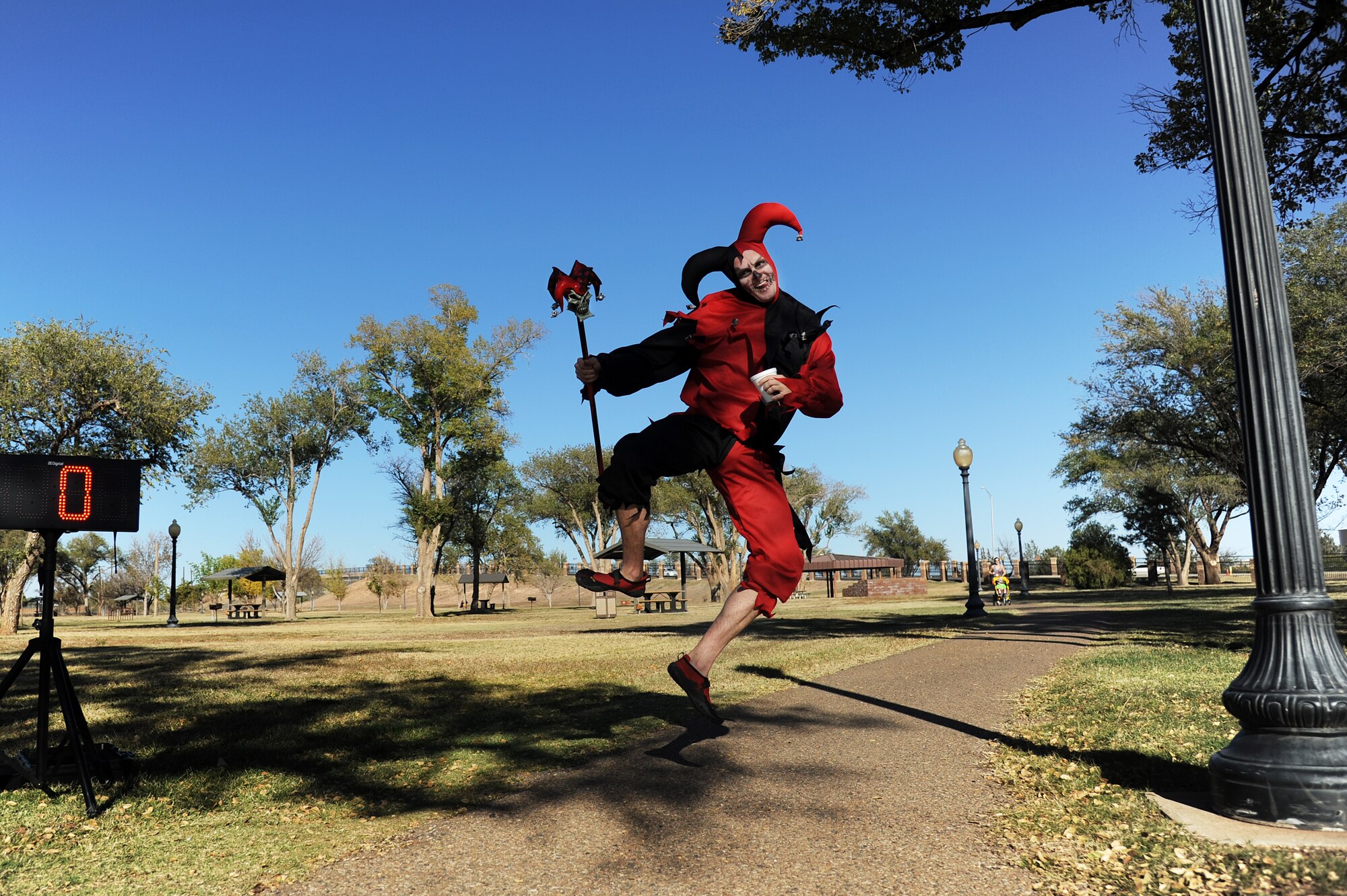 Staff Sgt. Rex Walton, 27th Special Operations Civil Engineer Squadron, takes a hop, skip and a jump across the finish line during the Spooky 5K at Cannon Air Force Base, N.M., Oct. 31, 2012.  As a last hurrah to Halloween, the 27th Special Operations Force Support Squadron hosted the fast-paced event. (U.S. Air Force photo/Senior Airman Jette Carr)