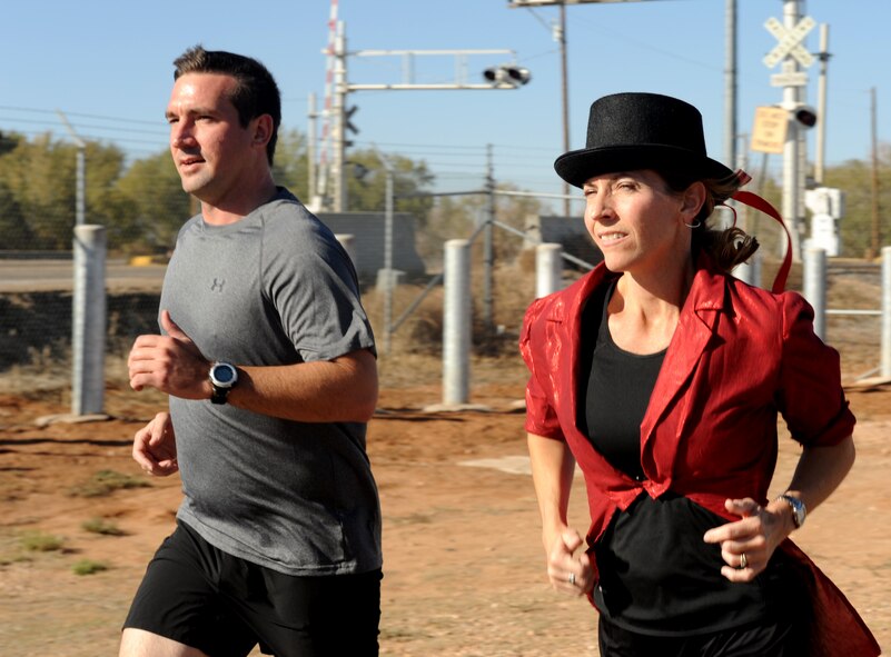 U.S. Air Force Tech. Sgt. Nick Peloquin, 551st Special Operations Squadron loadmaster, runs with his spouse Kendra, during the Spooky 5K at Cannon Air Force Base, N.M., Oct. 31, 2012. The 27th Special Operations Force Support Squadron hosted the event, which was open to Airmen as well as dependents. (U.S. Air Force photo/Airman 1st Class Xavier Lockley)