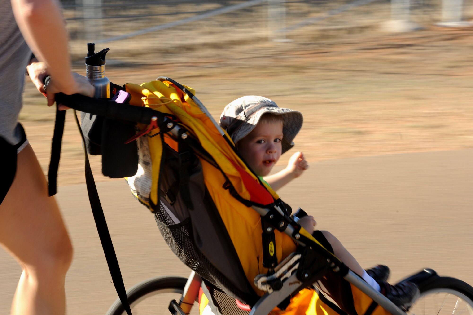 An Air Commando and child run during the Spooky 5K at Cannon Air Force Base, N.M., Oct. 31, 2012. The 27th Special Operations Force Support Squadron hosted the event, which was open to Airmen and dependents. (U.S. Air Force photo/Airman 1st Class Xavier Lockley)