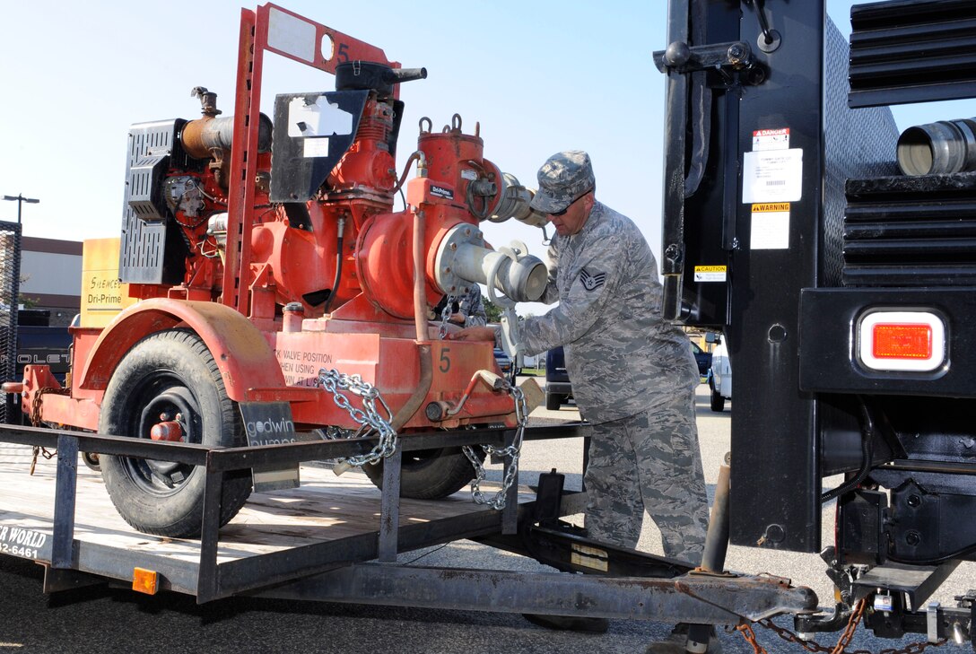 U.S. Air Force Staff Sgt. Michael Smith, 633rd Civil Engineer Squadron water fuels systems journeyman, secures a water pump for transport at Langley Air Force Base, Va., Nov. 2, 2012. The water pump is one of two supplied by the 633rd CES in response to Hurricane Sandy relief efforts in New York. (U.S. Air Force photo by Staff Sgt. Krystie Martinez/Released)