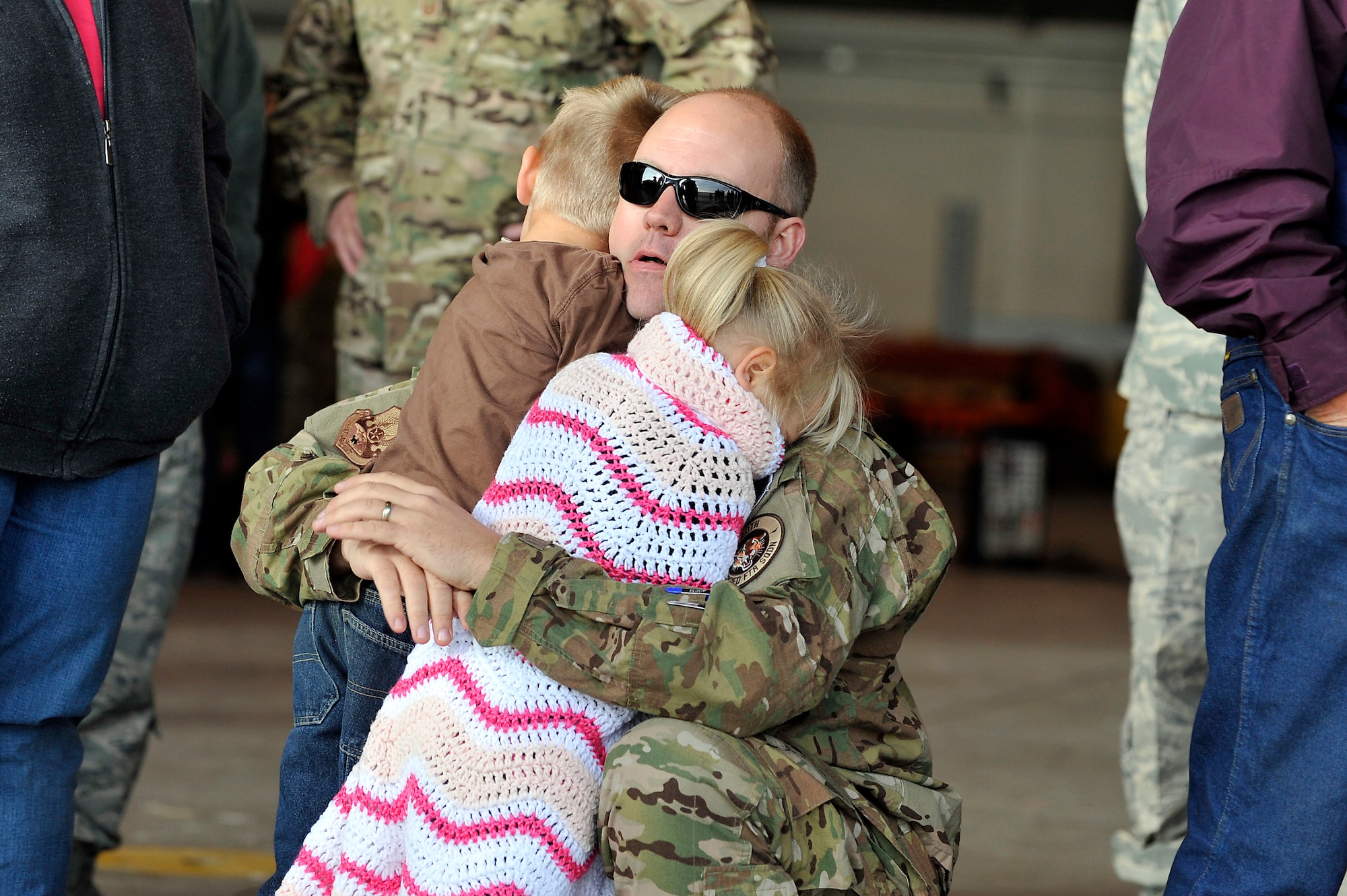 U.S. Air Force Master Sgt. Matthew Morris, 140th Maintenance Squadron, hugs his kids goodbye at Buckley Air Force Base Colo., Nov 1, 2012.  Members of the 140th Wing, Colorado Air National Guard, have been taking off from Buckley AFB, Colo. this week, headed to a forward operating location in support of Air Force Central Command. These pilots, aircraft maintainers and support personnel will be deployed throughout the holiday season in order to support the ongoing Overseas Contingency Operations. (Colorado Air National Guard photo by Tech. Sgt. Wolfram M. Stumpf)