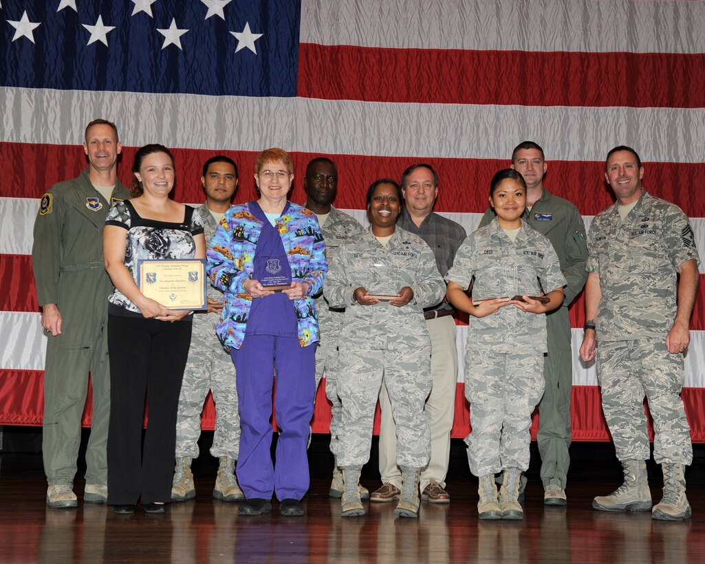 The 2012 third quarterly award winners or their representatives pause for a photo on stage at Kaye Auditorium Oct. 30. (U.S. Air Force photo/Elizabeth Owens)