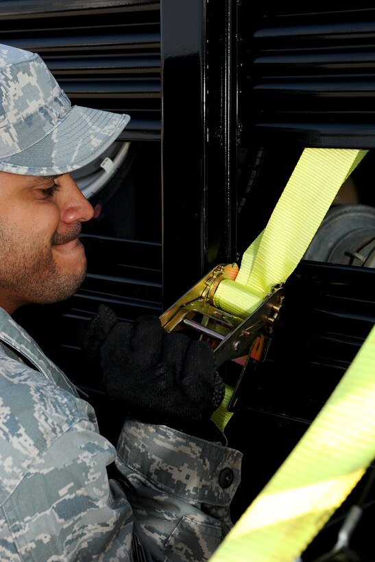 U.S. Air Force Staff Sgt. Alexis Lopez, 633rd Civil Engineer Squadron water fuels systems journeyman, fastens equipment to a truck at Langley Air Force Base, Va., Nov 2, 2012. Members of the 633rd CES hauled water pumps, pipes and other necessary equipment to Joint Base McGuire-Dix-Lakehurst, N.J. to assist the 331st Air Expeditionary Group in providing relief for those affected by Hurricane Sandy in New York. (U.S. Air Force photo by Staff Sgt. Ashley Hawkins/Released)