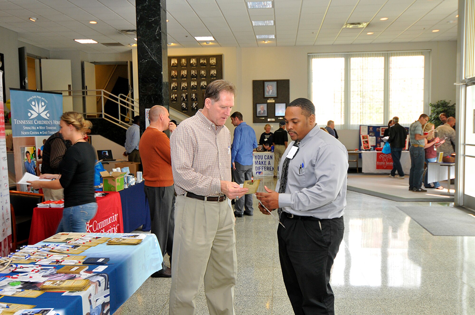 Strength for Service director Larry Coppock explains the organization’s mission to Artious Walker, an AEDC Acquisitions project manager. (Photo by Jacqueline Cowan)