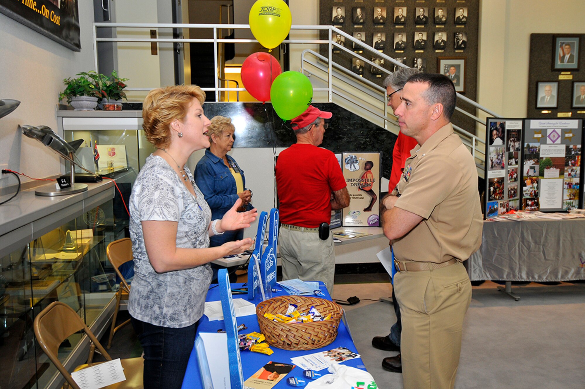 Juvenile Diabetes Research Foundation (JDRF) representative Cathy Manis talks to Navy Cmdr. Brian Allen, Arnold Engineering Development Complex (AEDC) Test Division chief, at the recent annual Combined Federal Campaign (CFC) fair held in the lobby of the A&E Building at AEDC. (Photo by Jacqueline Cowan)