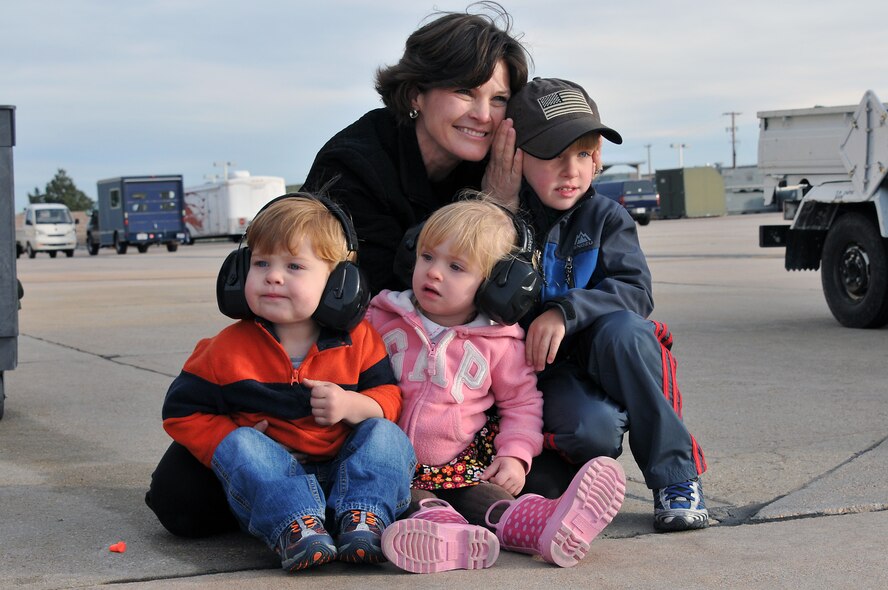 U.S. Air Force Lt. Col. Tracy LaTourrette along with her three children waits for her husband, U.S. Air Force Major TanEyck “Thor” LaTourrrette (not pictured), 120th Fighter Squadron, to take off from Buckley Air Force Base Colo., Nov 1, 2012.  Members of the 140th Wing, Colorado Air National Guard, have been taking off from Buckley AFB, Colo. this week, headed to a forward operating location in support of Air Force Central Command. These pilots, aircraft maintainers and support personnel will be deployed throughout the holiday season in order to support the ongoing Overseas Contingency Operations. (Colorado Air National Guard photo by Tech. Sgt. Wolfram M. Stumpf)