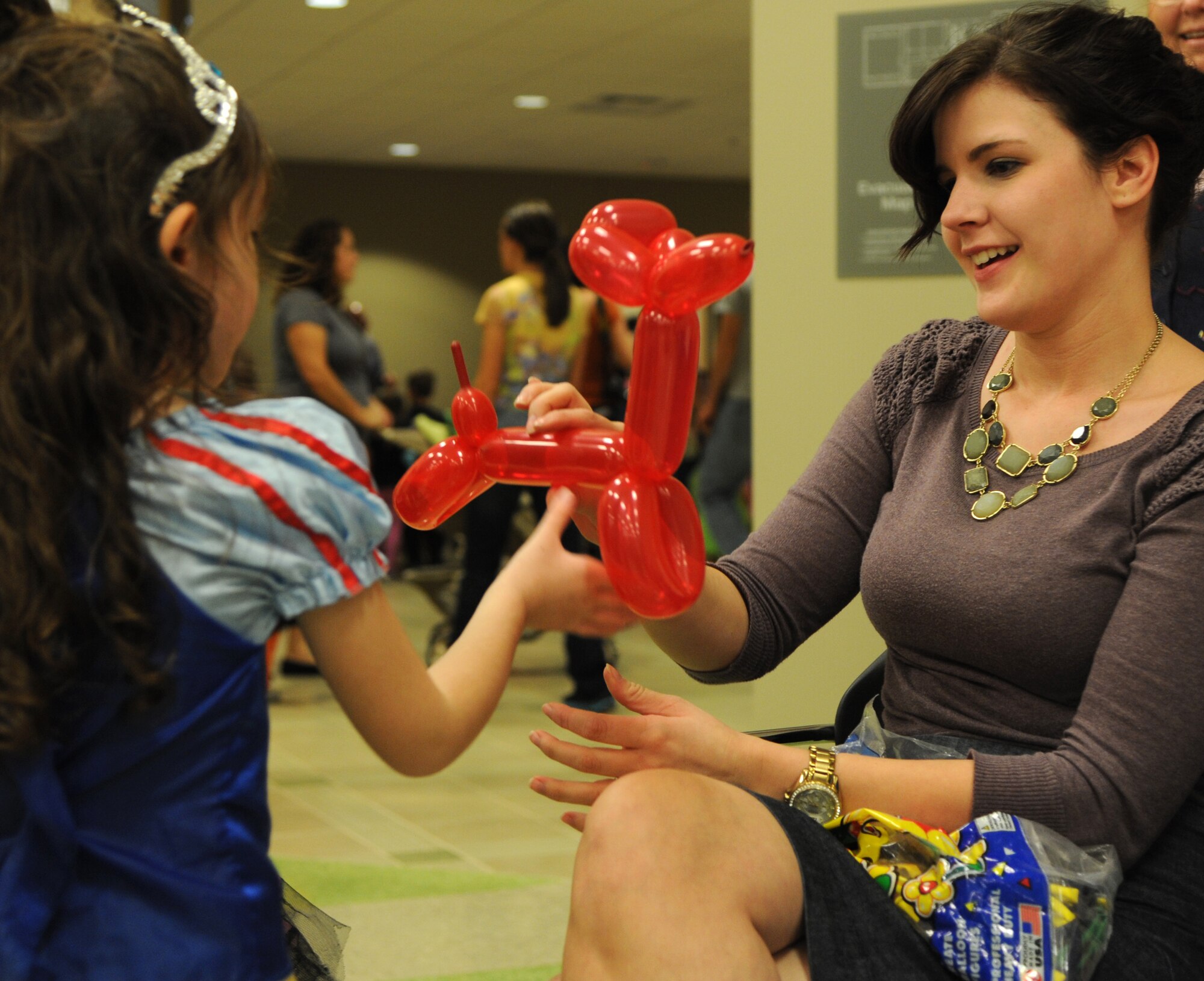 Amanda DeHart, right, with the Airman & Family Readiness Center, creates a balloon animal for a Halloween-costumed attendee at the 2012 Fall Fest held Oct. 30 in the Armed Forces Reserve Center at Vance Air Force Base, Okla. (U.S. Air Force photo/ Airman 1st Class Frank Casciotta)