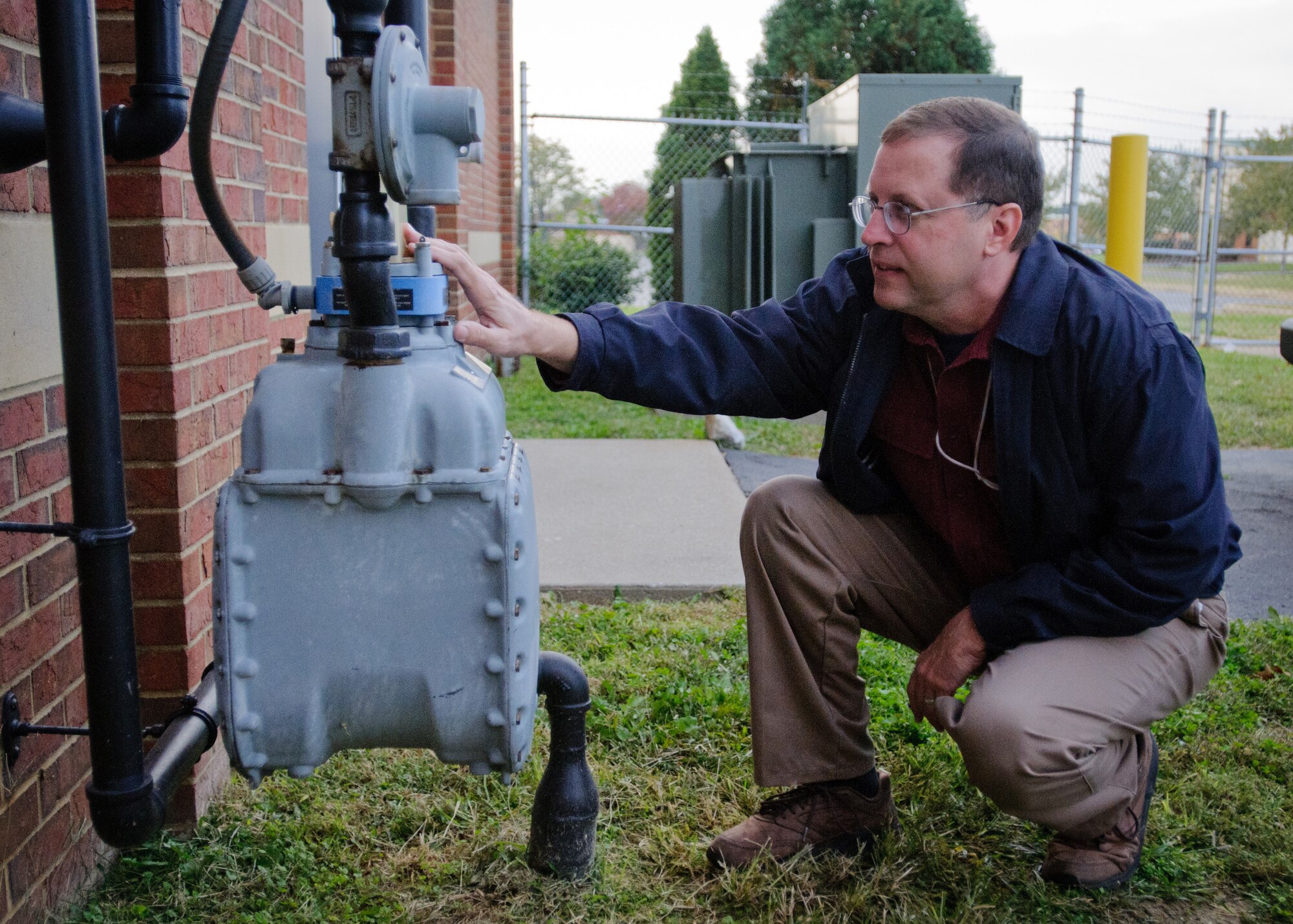 Tom Spalding, an environmental technician for the 123rd Airlift Wing, checks a gas meter Oct. 12, 2012, at the Kentucky Air National Guard base in Louisville, Ky. Many of the meters on base wirelessly transmit energy-usage data for monthly reports, helping officials identify opportunities to reduce energy consumption. (Kentucky Air National Guard photo by Master Sgt. Phil Speck)