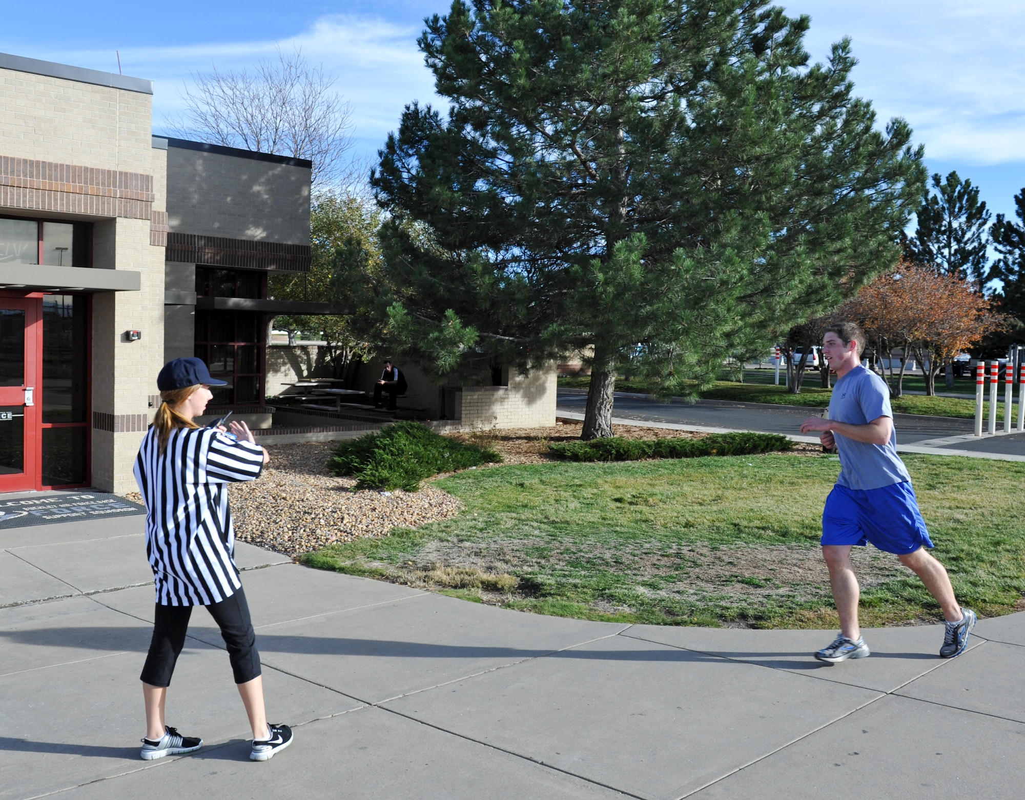 BUCKLEY AIR FORCE BASE, Colo. – Heather Huckstep, left, Buckley Fitness Center recreational assistant, congratulates Capt. John Radar, 566th Intelligence Squadron, as he wins Buckley's Dreadful Dash 5K Oct. 31, 2012. The race started at the fitness center track and concluded at the community center. (U.S. Air Force photo by Senior Airman Christopher Gross)