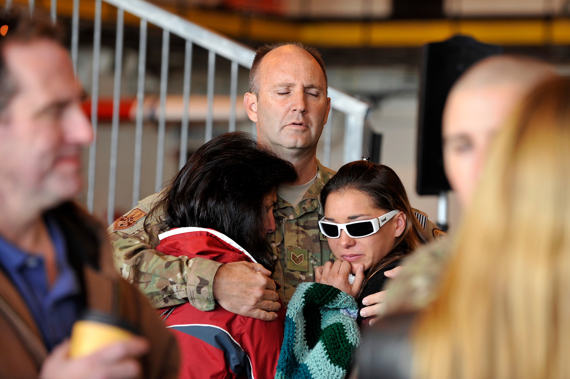 U.S. Air Force Staff Sgt. Rob Bruning, 140th Maintenance Squadron, hugs his wife and daughter goodbye at Buckley Air Force Base Colo., Nov 1, 2012.  Members of the 140th Wing, Colorado Air National Guard, have been taking off from Buckley AFB, Colo. this week, headed to a forward operating location in support of Air Force Central Command. These pilots, aircraft maintainers and support personnel will be deployed throughout the holiday season in order to support the ongoing Overseas Contingency Operations. (Colorado Air National Guard photo by Tech. Sgt. Wolfram M. Stumpf)