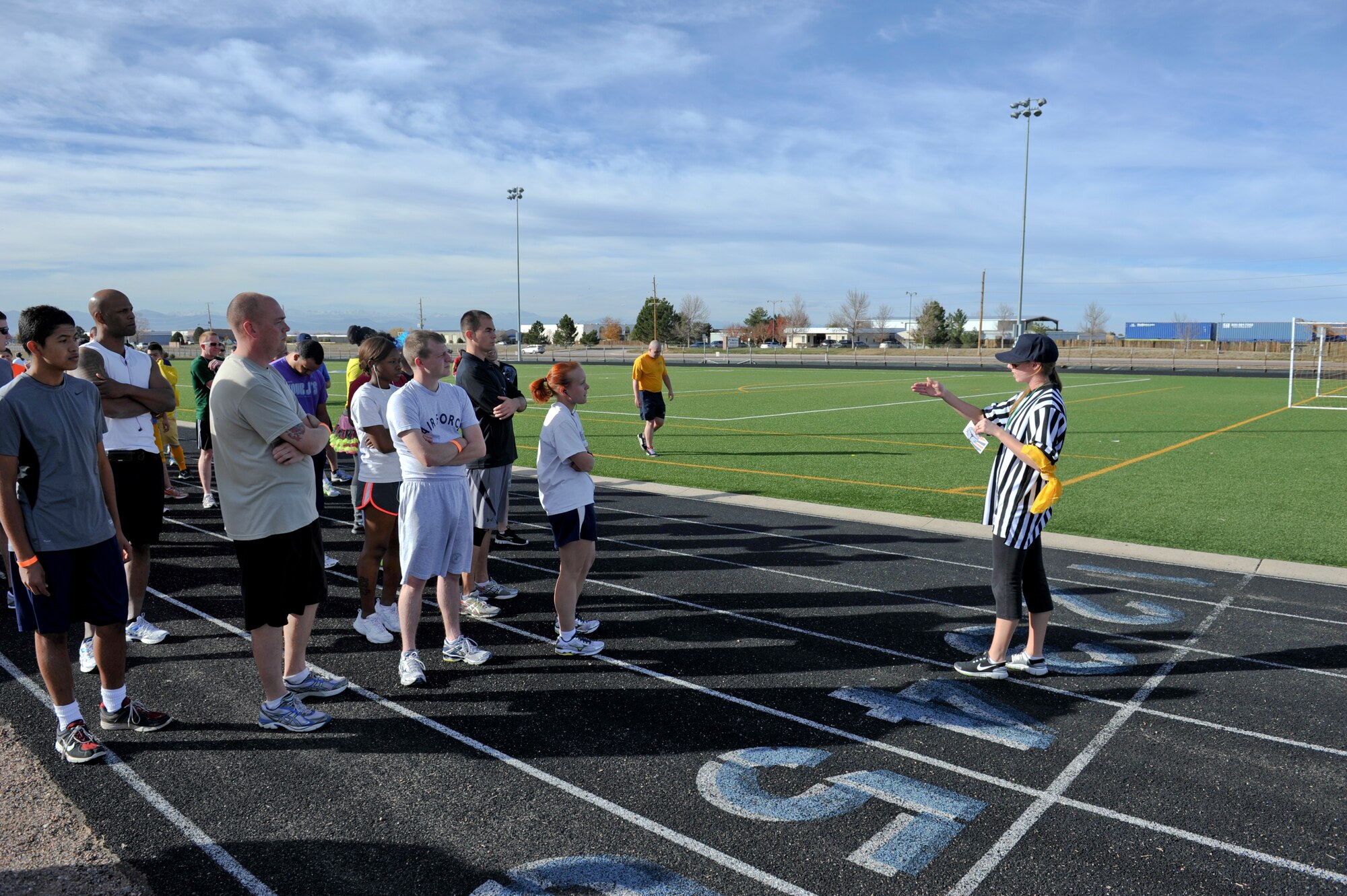BUCKLEY AIR FORCE BASE, Colo. – Heather Huckstep, right, Buckley Fitness Center recreational assistant, reads instructions to runners before the start of Buckley's Dreadful Dash 5K Oct. 31, 2012, at the fitness center track. Capt. John Radar, 566th Intelligence Squadron, won the race. (U.S. Air Force photo by Senior Airman Christopher Gross)