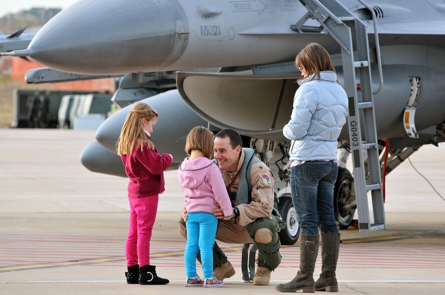 U.S. Air Force Maj. Mike “Stiffler” Gommel, 120th Fighter Squadron, says goodbye to his daughters, Dylan (left) and Harlie (center) and his wife, Jennifer at Buckley Air Force Base Colo., Nov 1, 2012.  Members of the 140th Wing, Colorado Air National Guard, have been taking off from Buckley AFB, Colo. this week, headed to a forward operating location in support of Air Force Central Command. These pilots, aircraft maintainers and support personnel will be deployed throughout the holiday season in order to support the ongoing Overseas Contingency Operations. (Colorado Air National Guard photo by Tech. Sgt. Wolfram M. Stumpf)