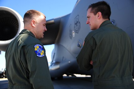 Senior Airman Blake Douglas, 437th Aircraft Maintenance Squadron crew chief, briefs 1st Lt. Jonathon Lewcyzyk, 16th Airlift Squadron co-pilot, on the inspection status of a C-17 Globemaster III during their pre-flight checks before takeoff Nov. 1, 2012, at Joint Base Charleston – Air Base, S.C. The aircrew was dispatched to pick up supplies and cadaver teams and deliver them to assist with the relief efforts for Hurricane Sandy affecting the Northeast. (U.S. Air Force photo /Staff Sgt. Rasheen Douglas)