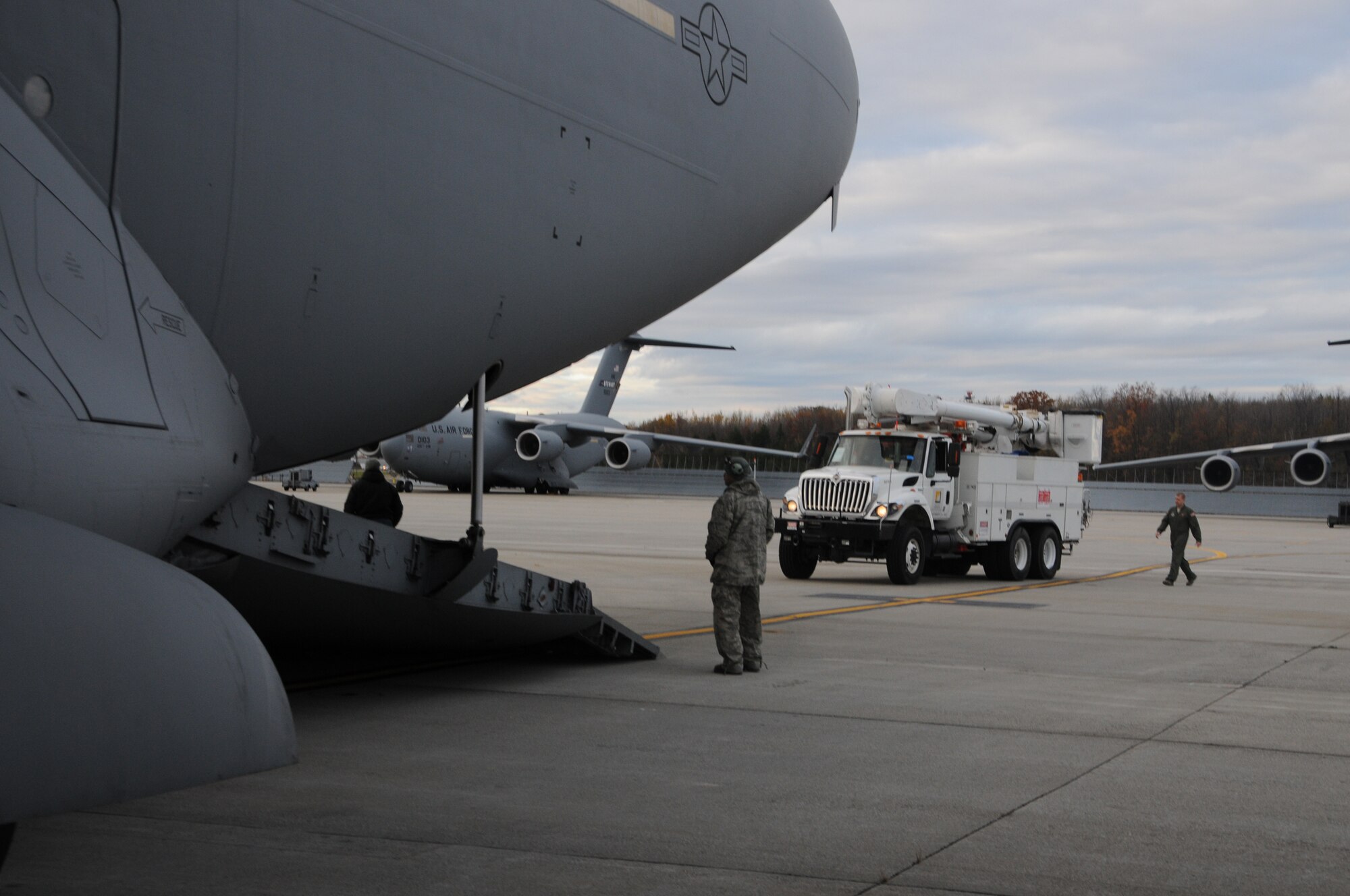 WRIGHT-PATTERSON AIR FORCE BASE, Ohio - Airmen unload five utility trucks and 26 personnel from the Southern California Edison utility company from a 445th Airlift Wing C-17 Globemaster III at Stewart Air National Guard Base, Newburgh, N.Y., Nov. 2, in support of the humanitarian relief efforts to restore power to the areas affected by Hurricane Sandy. (U.S. Air Force photo/Tech. Sgt. Anthony Springer)