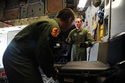 (Left) Airman 1st Class Dwayne Baldwin and Staff Sgt. Robert Strecker, loadmasters from the 16th Airlift Squadron and14th Airlift Squadron, discuss flight preparations during their pre-flight checks before takeoff Nov. 1, 2012, on C-17 Globemaster III at Joint Base Charleston, S.C. The aircrew was dispatched to pick up supplies and cadaver teams and deliver them to assist with the relief efforts for Hurricane Sandy affecting the Northeast. (U.S. Air Force photo/Staff Sgt. Rasheen Douglas)