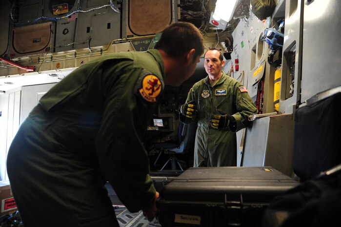 (Left) Airman 1st Class Dwayne Baldwin and Staff Sgt. Robert Strecker, loadmasters from the 16th Airlift Squadron and14th Airlift Squadron, discuss flight preparations during their pre-flight checks before takeoff Nov. 1, 2012, on C-17 Globemaster III at Joint Base Charleston – Air Base, S.C. The aircrew was dispatched to pick up supplies and cadaver teams and deliver them to assist with the relief efforts for Hurricane Sandy affecting the Northeast. (U.S. Air Force photo /Staff Sgt. Rasheen Douglas)