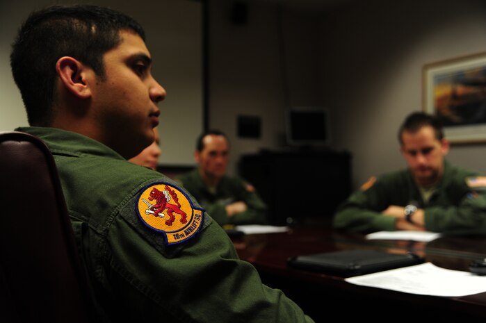 Airman 1st Class Dwayne Baldwin, 16th Airlift Squadron loadmaster, listens to a mission brief before takeoff Nov. 1, 2012, at Joint Base Charleston – Air Base, S.C. The aircrew was tasked to fly to March Reserve Air Force Base, Calif., to pick up supplies and cadaver teams and deliver them to assist with the relief efforts for Hurricane Sandy affecting the Northeast. (U.S. Air Force photo /Staff Sgt. Rasheen Douglas)