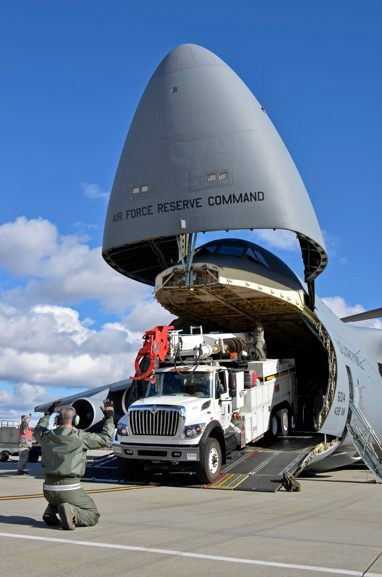 In response to President Obama's call for the government to support Hurricane Sandy relief efforts, a Westover C-5B flew to March Air Reserve Base, Calif., picked up 73 electrical workers and two utility trucks, and dropped them off at Stewart Air National Guard Base, N.Y. hours later. The workers and equipment will augment relief efforts in New York and New Jersey. (U.S. Air Force photo/SrA. Kelly Galloway)