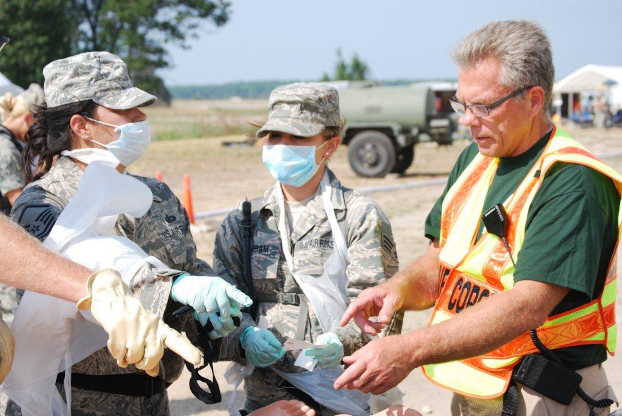 Kentucky Air National Guard Senior Airman Shelby Basham (center), a Fatality Search and Recovery Team member, talks to other FSRT members and the on-scene coroner during Patriot 12, a disaster-response exercise held at Volk Field, Wis., from July 13-20, 2012. The Kentucky Air Guard joined with the Arizona and Minnesota Air Guard FSRTs to train a newly established Indiana team during the exercise. (Courtesy Photo)