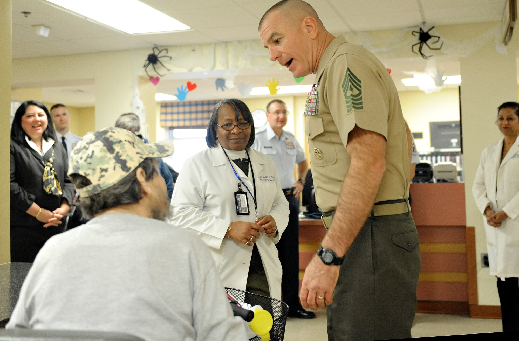 Sgt. Maj. Bryan Battaglia, Senior Enlisted Advisor to the Chairman Joint Chiefs of Staff, speaks with a veteran while touring a physical medicine and rehabilitation center Oct. 31 in St. Louis, MO. Battaglia serves as the principal advisor to the Chairman and Secretary of Defense on all matters involving joint and combined total force integration, utilization, health of the force and joint development for enlisted personnel. (U.S. Air Force photo/Airman Kris Lynch)