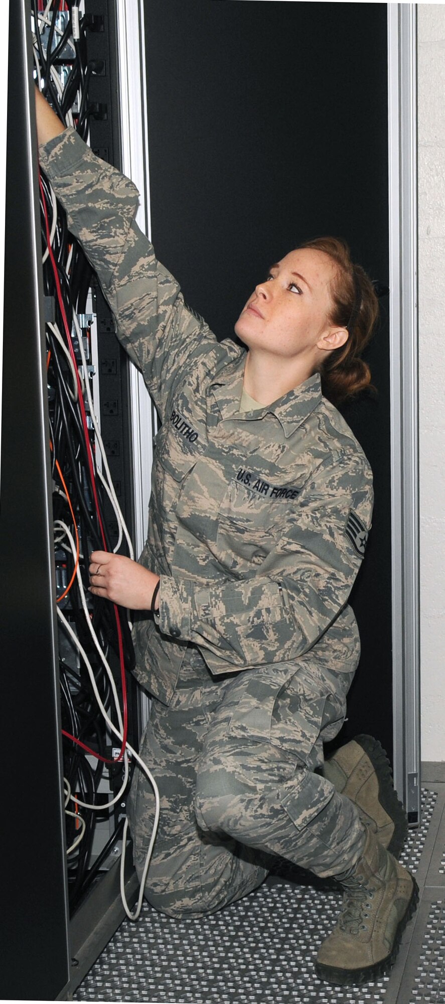 U.S. Air Force Staff Sergeant Carley Bolitho, 612th Air Communications Maintenance Squadron communications control administrator, checks the wiring at the back of a server on Davis-Monthan Air Force Base, Ariz., Nov. 1, 2012. The 612th ACOMS handles communications issues for the 612th Air Communications Squadron. (U.S. Air Force photo by Airman 1st Class Saphfire Cook/Released)