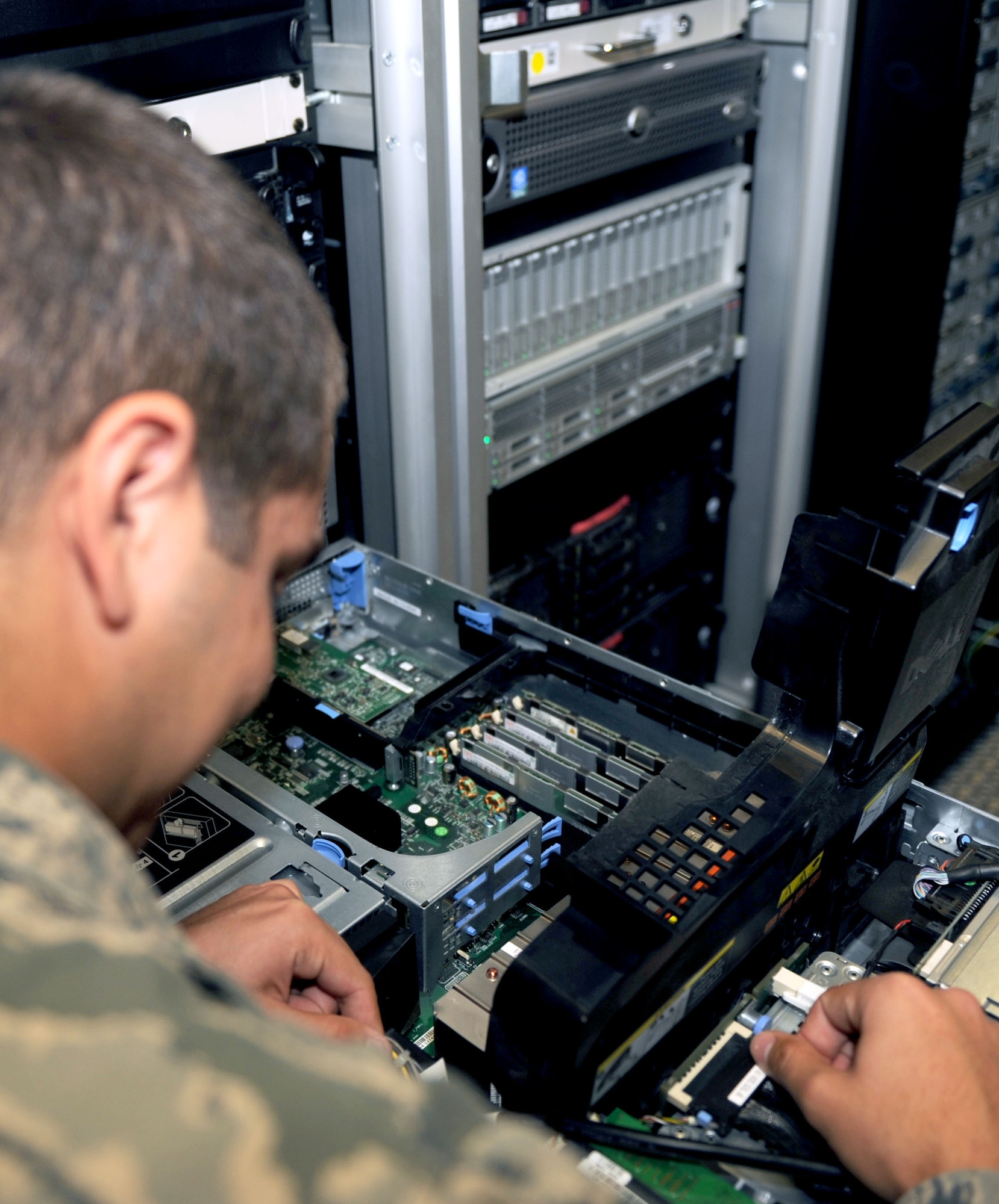 U.S. Air Force Airman 1st Class Steven Iguado, 612th Air Communications Maintenance Squadron communications control administrator, performs maintenance on a server on Davis-Monthan Air Force Base, Ariz., Nov. 1, 2012. The 612th ACOMS performs routine checks of their system every day. (U.S. Air Force photo by Airman 1st Class Saphfire Cook/Released)