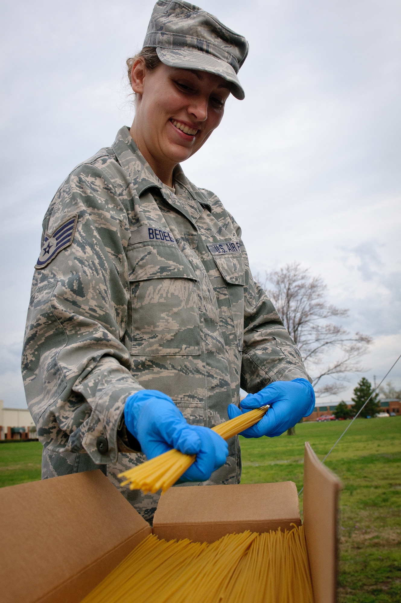 Senior Airman Amanda Bedel of the 123rd Force Support Squadron prepares to cook spaghetti during training on a new field kitchen at the Kentucky Air National Guard Base in Louisville, Ky., on March 16, 2012. The kitchen can be deployed to the site of a natural disaster to provide hot meals for relief workers. (U.S. Air Force photo by Senior Airman Maxwell Rechel)