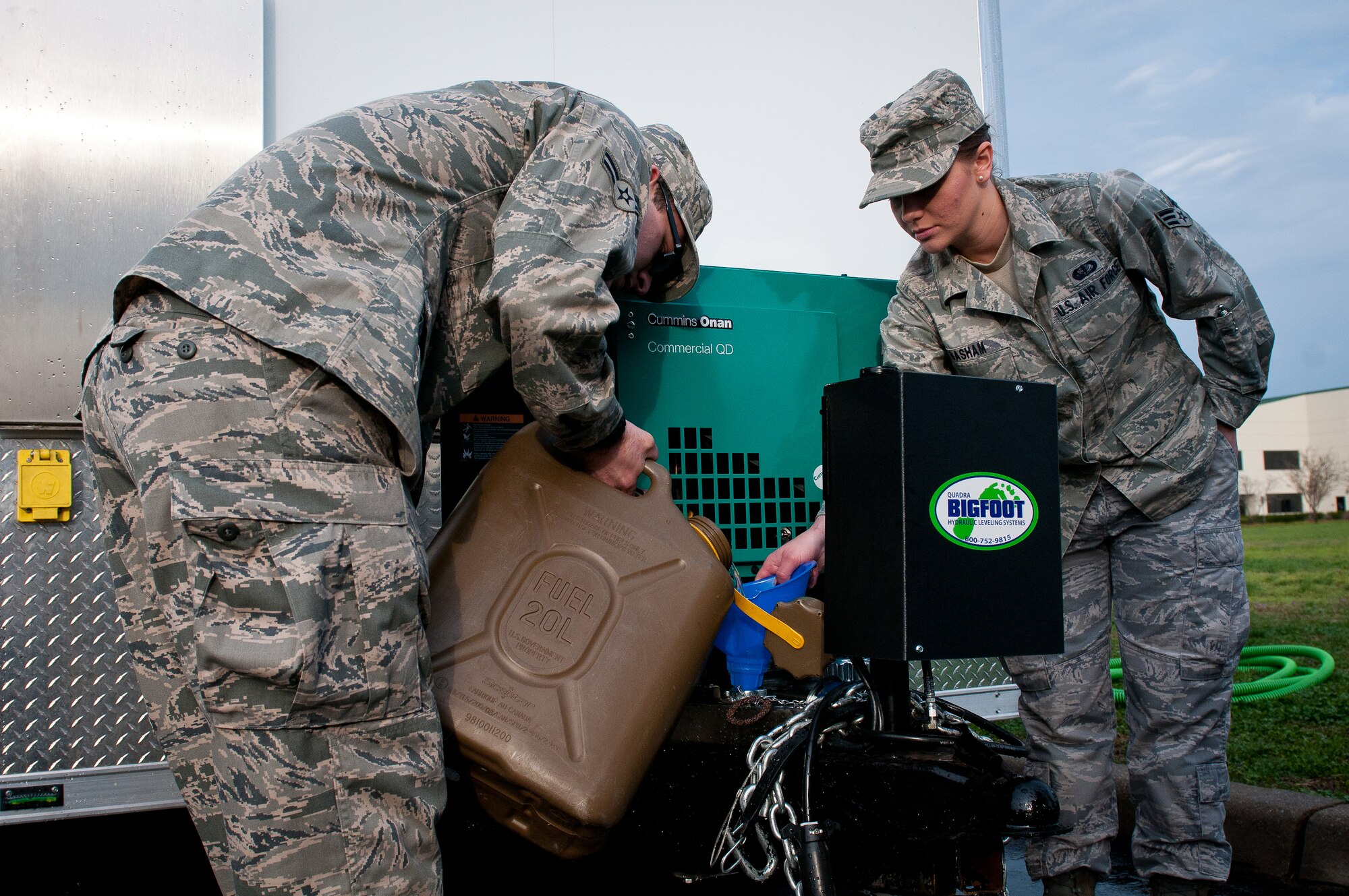 Senior Airman Christian King, left, and Senior Airman Shelby Basham, right, of the 123rd Force Support Squadron fuel a new mobile field kitchen during training at the Kentucky Air National Guard Base in Louisville, Ky., on March 16, 2012. The kitchen can be deployed to the site of a natural disaster to provide hot meals for relief workers. (U.S. Air Force photo by Senior Airman Maxwell Rechel)