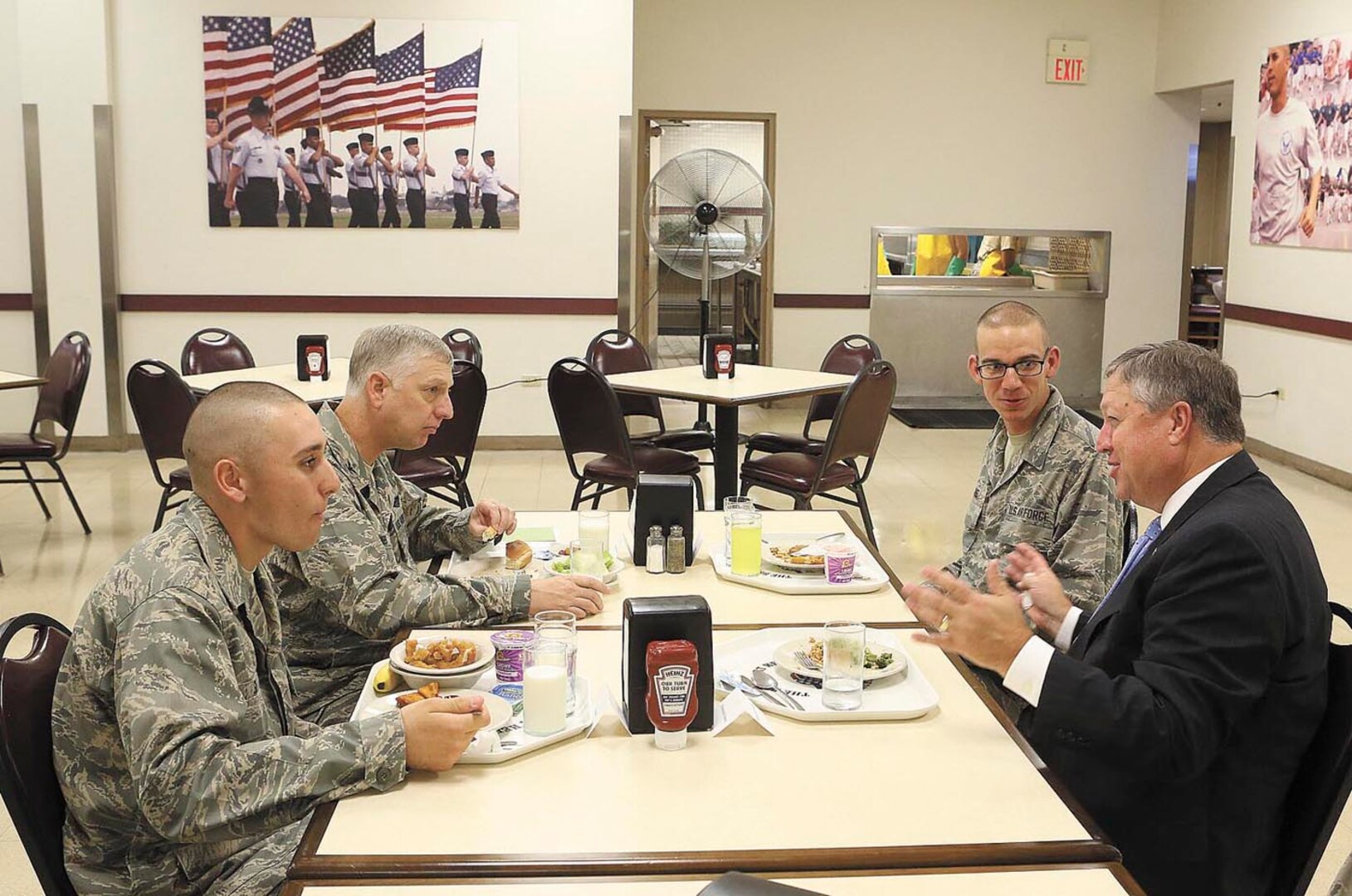 Left to right, Air Force basic military trainee Alexander Silva, Col. Mark D. Camerer, 37th Training Wing commander, and trainee Spencer Marks, have lunch with Secretary of the Air Force Michael Donley Oct. 23 at the 326th Training Squadron dining facility. During his visit to Joint Base San Antonio-Lackland, Donley met with Airmen from the 37th Training Wing. Silva and Marks are assigned to the 326th TRS’s Flight 675. (U.S. Air Force/Robbin Cresswell)