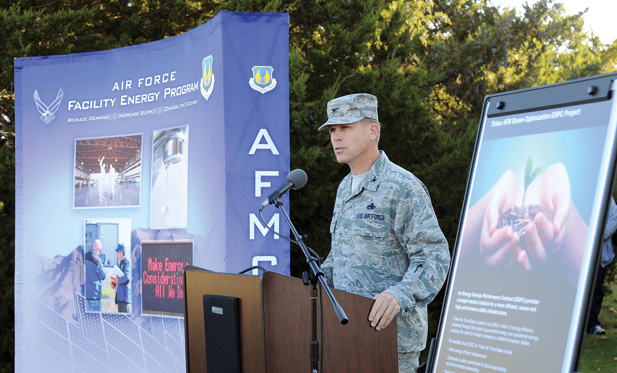 Col. Steven Bleymaier, 72nd Air Base Wing and Tinker installation commander, outlines Tinker’s continuing aggressive efforts to reduce energy consumption and save taxpayer dollars.  Positioned outside a base heating plant, Bldg. 5802, the commander spoke before joining local, command and contractor partners to cut a ceremonial ribbon signifying the private-public unified energy-reduction program. (Air Force photo by Margo Wright)