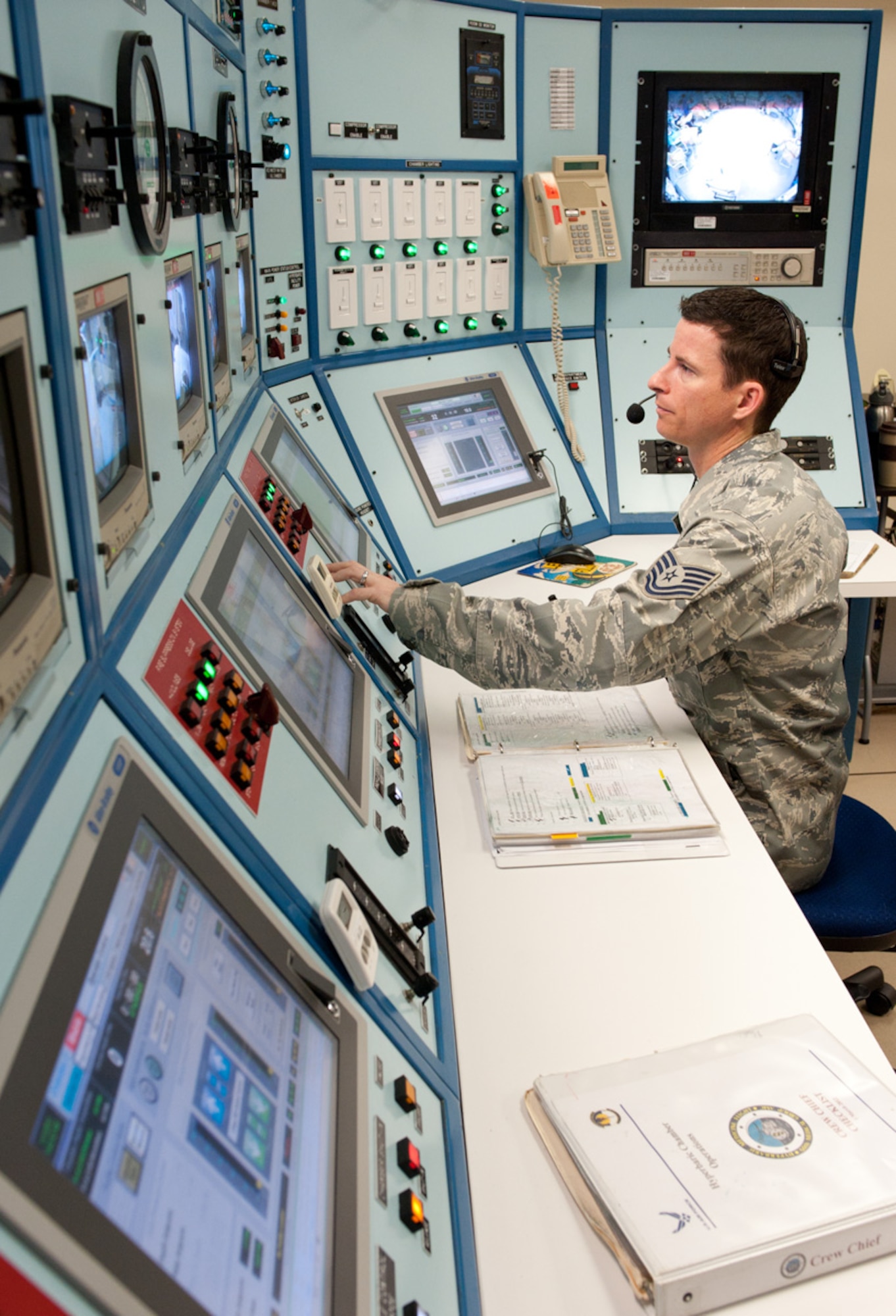 Tech. Sgt. James Colvin, the 60th Medical Group's Aerospace Physiology flight chief, moves through a pre-dive checklist at the hyperbaric chamber console. (U.S. Air Force Photo/Ken Wright)