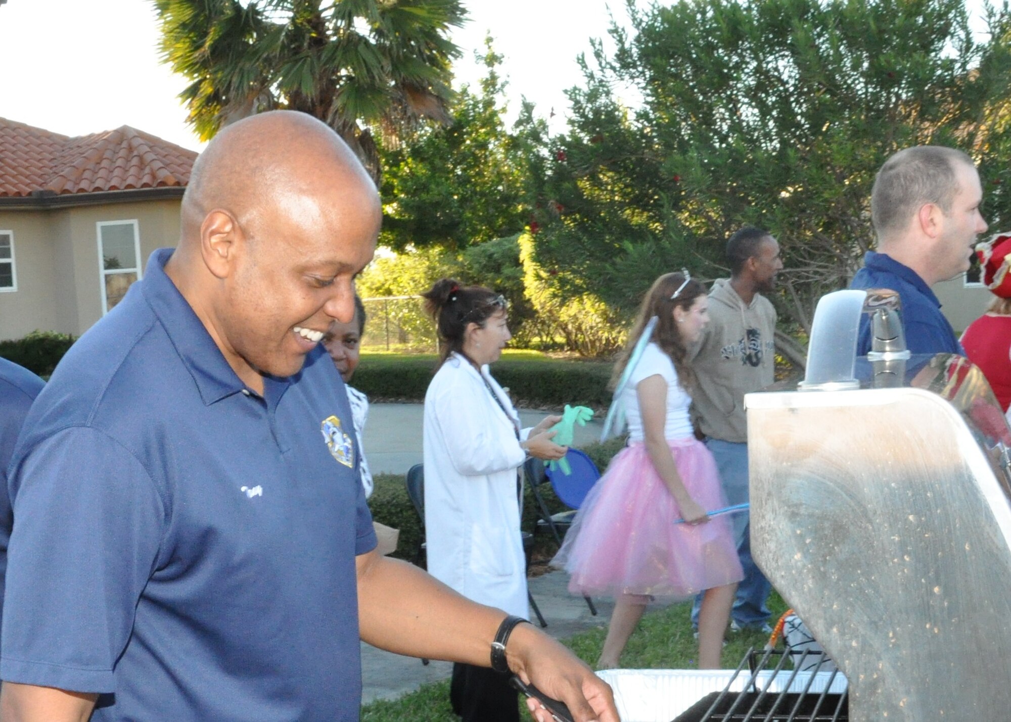 Brig. Gen. Anthony Cotton, 45th Space Wing commander, shows true service before self as he serves the base community at Reef Court. 