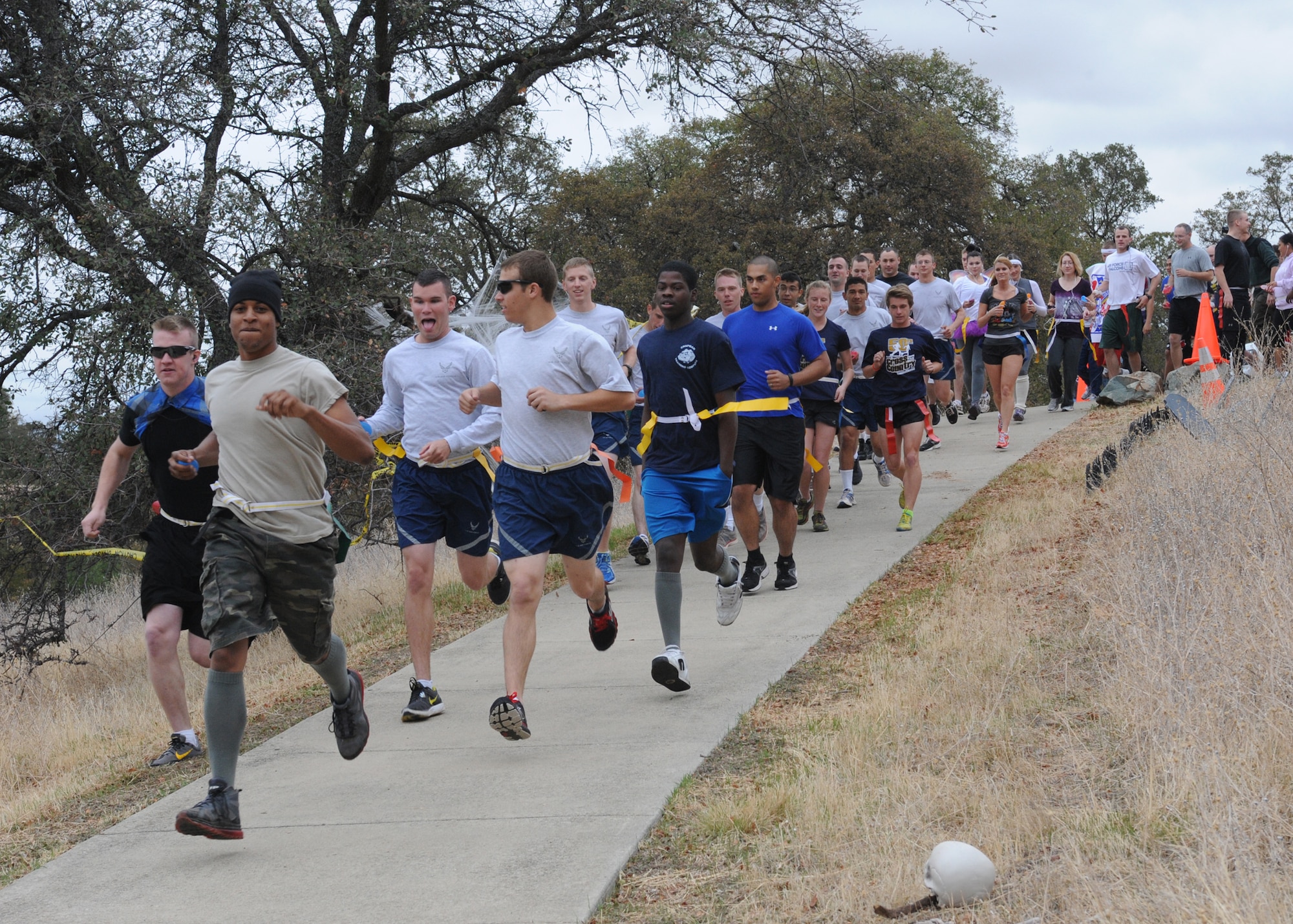 Members of Team Beale participate in the annual Zombie Run at Beale Air Force Base Calif., Oct. 31, 2012. The runners had to complete the 2.6 mile zombie-infested wooded course behind housing without losing their flags. (U.S. Air Force photo by 2nd Lt. Siobhan Bennett)