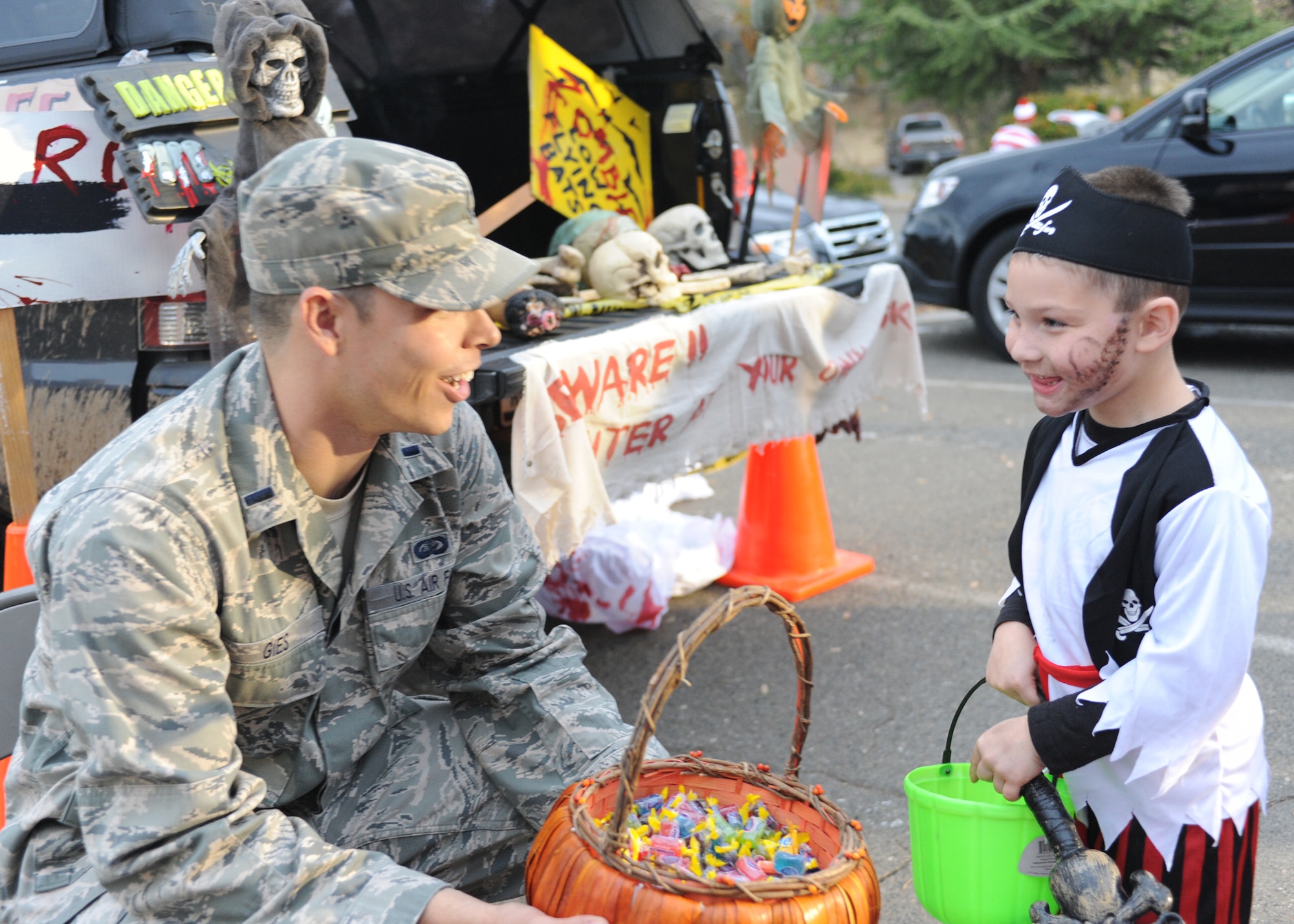 1st Lt. Michael Gies, 9th Reconnaissance Wing protocol officer, passes out candy during Team Beale’s annual Halloween Trunk or Treat at Ryden Park, Beale Air Force Base Calif., Oct. 31, 2012. Approximately 100 families brought their children to the event. (U.S. Air Force photo by 2nd Lt. Siobhan Bennett/Released)