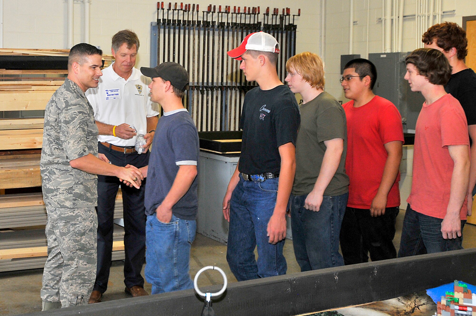 Arnold Engineering Development Complex Commander, Col. Raymond Toth (left) gives a special coin to students at Franklin County High School to congratulate them on a job well done. (Photo by Jackie Cowan)