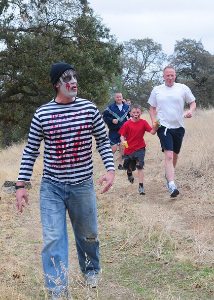Members of Team Beale participate in the 2nd annual Zombie Run at Beale Air Force Base Calif., Oct. 31, 2012. Runners were armed with water balloons to fend off any pursuing undead. (U.S. Air Force photo by Senior Airman Allen Pollard/Released)