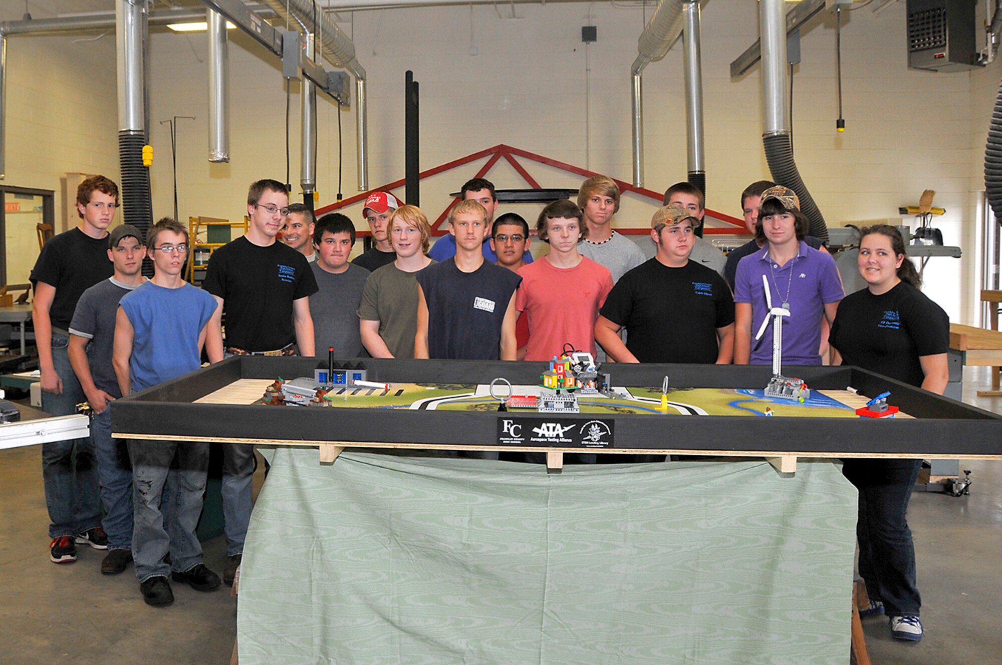 Members of Franklin County High School’s Carpentry Class stand behind one of the tables they built for Lego League Competition. (Photo by Jackie Cowan)