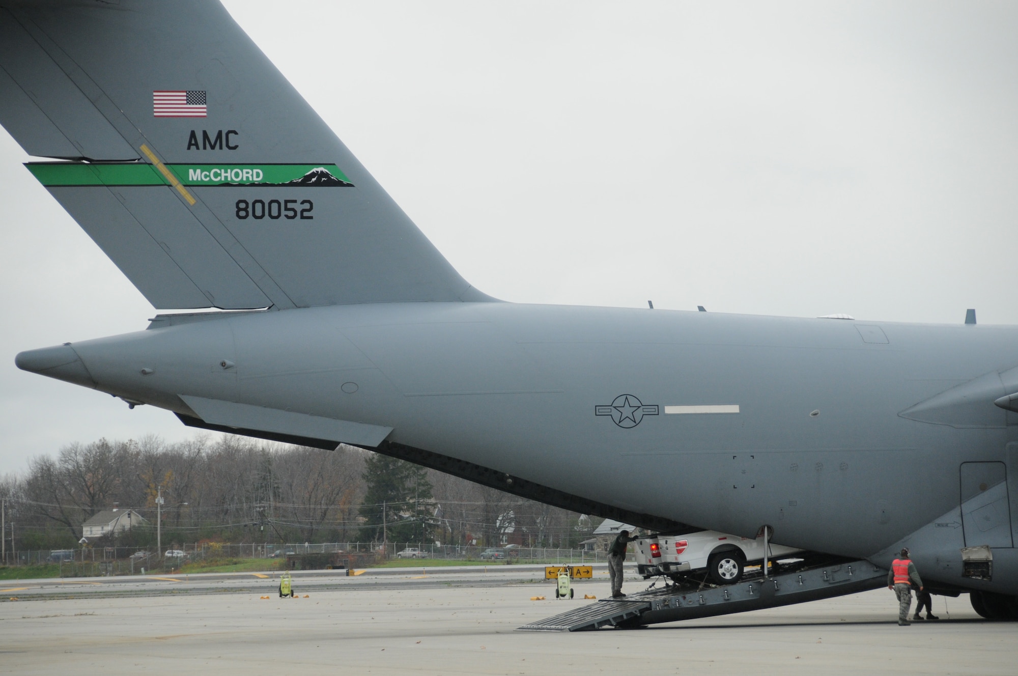 Support vehicles belonging to the Southern California Edison utility company are off-loaded from a McChord AFB C-17. The Globemaster carried support vehicles belonging to the Southern California Edison utility company that will support efforts to restore power and provide humanitarian assistance to the stricken region. (National Guard photo/Tech. Sgt. Michael Ohalloran)