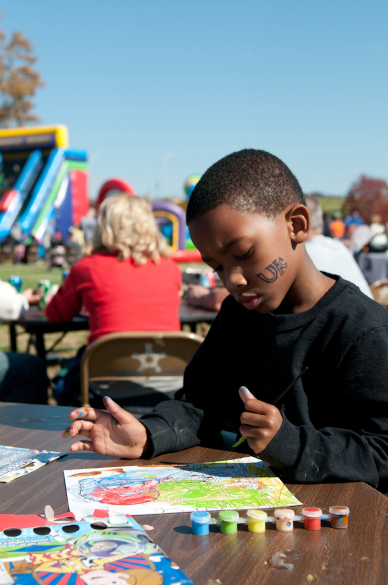 Adarius Hite, son of Kentucky Air National Guard member 2nd Lt. Angela Hite, paints pictures during family day at the 123rd Airlift Wing in Louisville, Ky., Oct. 21, 2012.  (Kentucky Air National Guard photo by Senior Airman Vicky Spesard)