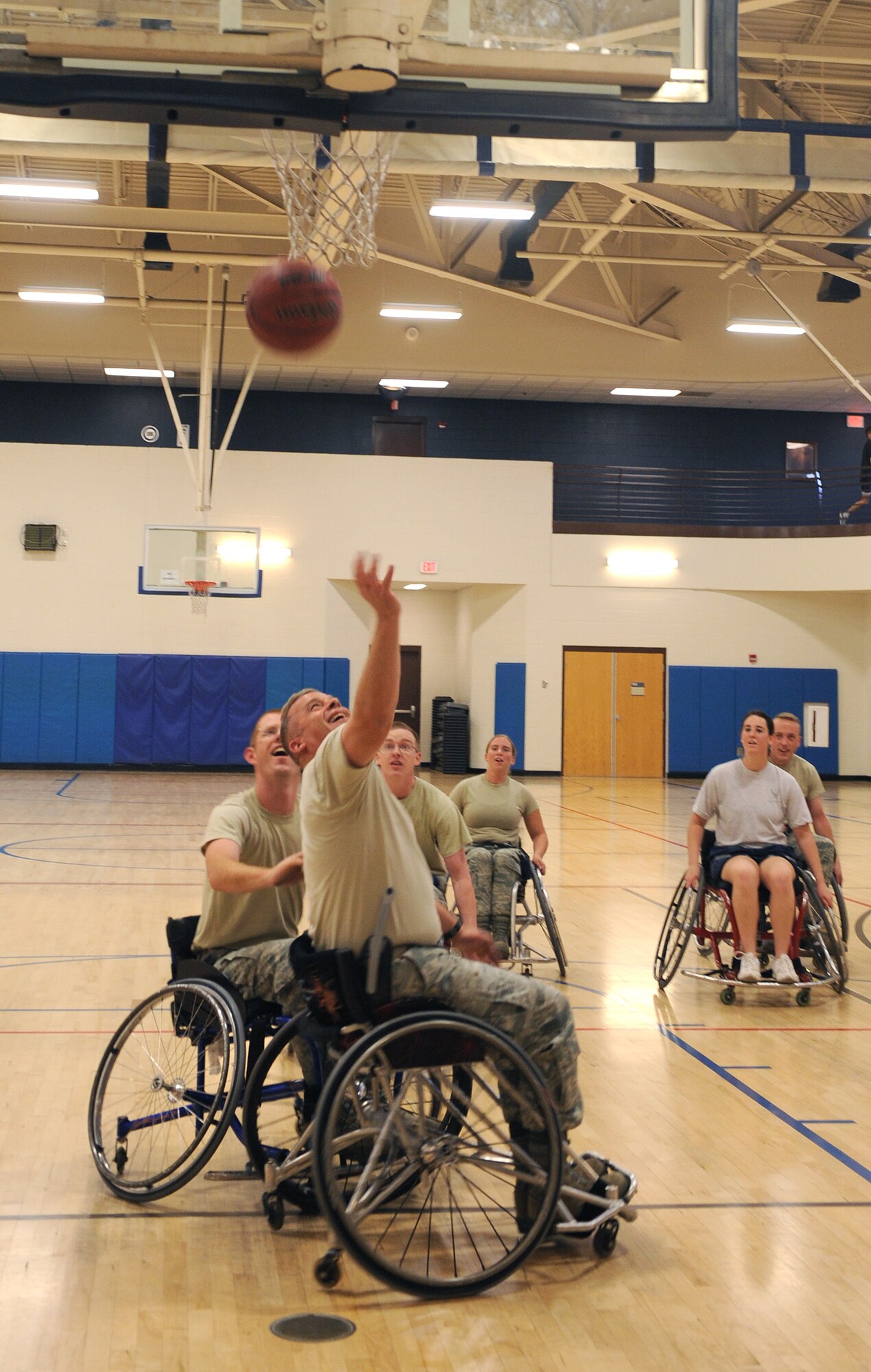 U.S. Air Force Senior Master Sgt. Matthew Gadziala, 355th Aircraft Maintenance Squadron first sergeant, shoots the ball during an adaptive sporting demonstration at the Benko Fitness Center on Davis-Monthan Air Force Base Oct. 30. The adaptive sporting demo was the first of its kind on D-M. The event marked the end of National Disability Employment Awareness Month. (U.S. Air Force photo by Senior Airman Brittany Dowdle/released)