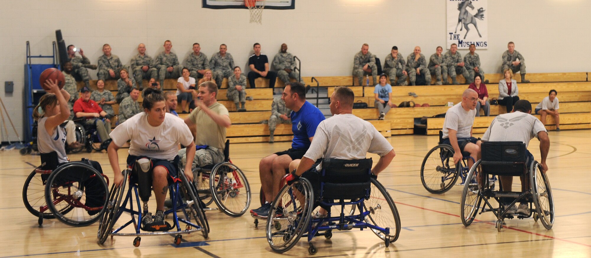 Members of the Desert Lightning Team and members from the University of Arizona adaptive athletics program play a friend game of wheelchair basketball during an adaptive sporting demonstration at the Benko Fitness Center on Davis-Monthan Air Force Base Oct. 30. The adaptive sporting demo was the first of its kind on D-M. The event marked the end of National Disability Employment Awareness Month. (U.S. Air Force photo by Senior Airman Brittany Dowdle/released)