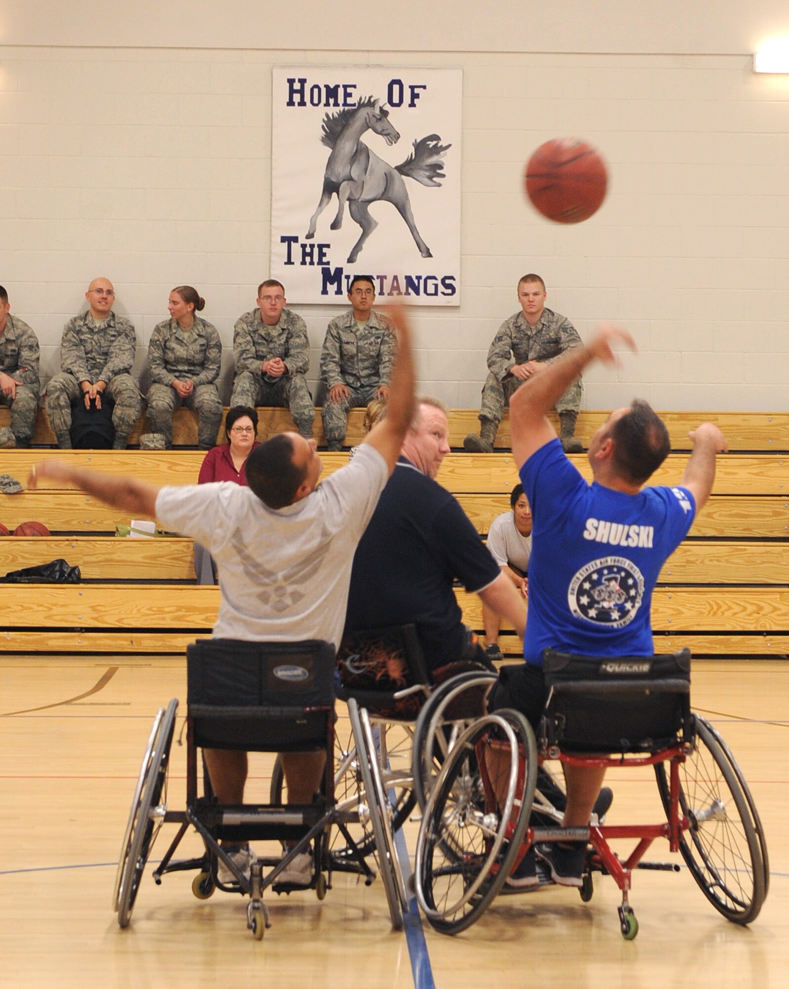 U.S. Air Force Senior Master Sgt. Hector Herrera, 355th Component Maintenance Squadron first sergeant, and Master Sgt. Steven Shulski, 355th Aircraft Maintenance Squadron first sergeant, tip off during an adaptive sporting demonstration at the Benko Fitness Center on Davis-Monthan Air Force Base Oct. 30. A team of six coed athletes from the University of Arizona came to D-M with extra sport wheelchairs to participate in a basketball exhibition against Air Force members. (U.S. Air Force photo by Senior Airman Brittany Dowdle/released)