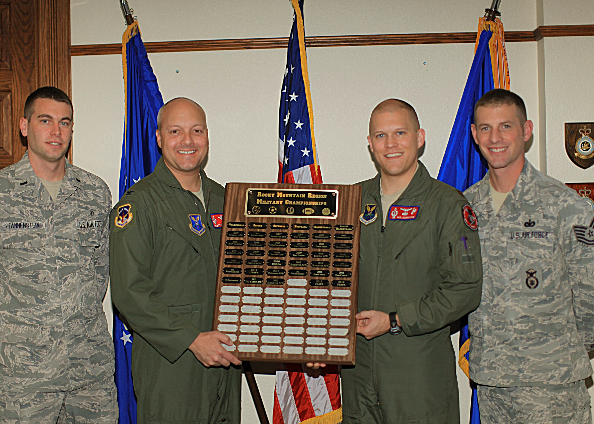 First Lt. Adam Pfannenstein, 90th Medical Operations Squadron bioenvironmental engineering officer-in-charge; Col. Christopher Coffelt, 90th Missile Wing commander; Maj. Paul Hendrickson, 319th Missile Squadron assistant operations officer; and Tech. Sgt. Joshua Hinsey, 90th Security Forces Squadron, pose with the Rocky Mountain Region Military Championship soccer plaque. Pfannenstein, Hendrickson and Hinsey represent F. E. Warren’s soccer team who recently took first place in the championship for the first time. (U.S. Air Force photo by Matt Bilden)