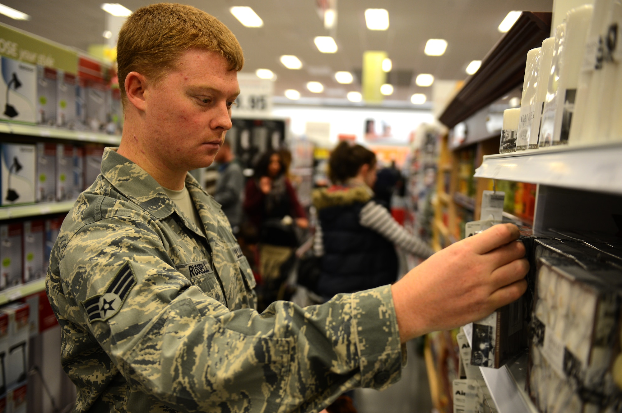SPANGDAHLEM AIR BASE, Germany – U.S. Air Force Senior Airman Jeffrey Russell, 52nd Comptroller Squadron budget and accounting technician from West Palm Beach, Fla., searches for items during the grand opening ceremony of the Spangdahlem Exchange Nov. 2, 2012.  Base leadership expects the Exchange to generate $2.4 million in revenue per month, with some of the proceeds going back into the Spangdahlem community. (U.S. Air Force photo by Airman 1st Class Gustavo Castillo/Released)