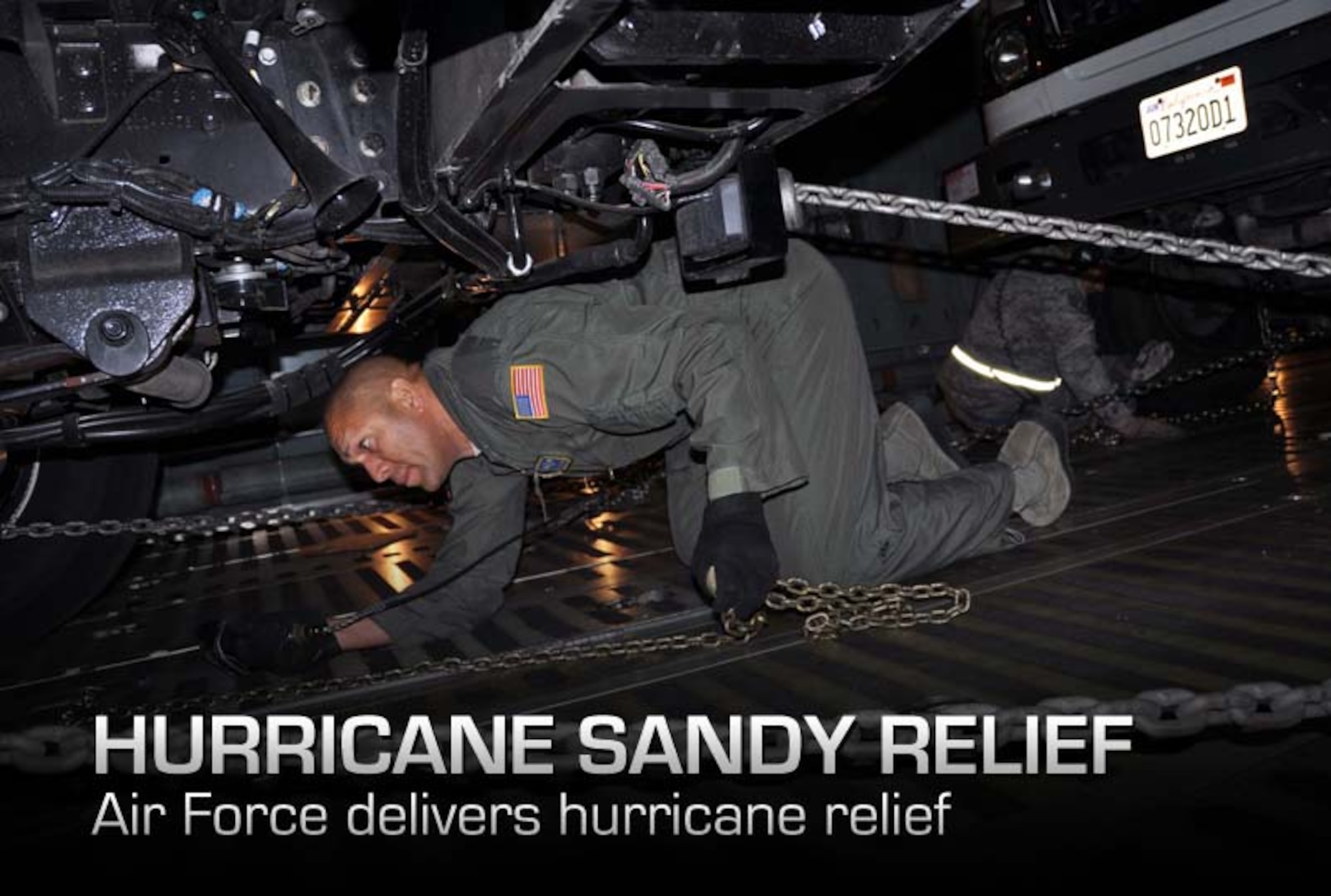 Reservists and technicians from March Air Reserve Base, Calif., answered the President's call to 'lean forward' with Hurricane Sandy relief efforts here Nov. 1, 2012, by loading Southern California Edison equipment onto a Travis Air Force Base C-5 Galaxy and a Joint Base Lewis-McChord C-17 Globemaster III. Here an Edison truck is marshalled into the cargo bay of a C-5. (U.S. Air Force photo/Linda Welz)