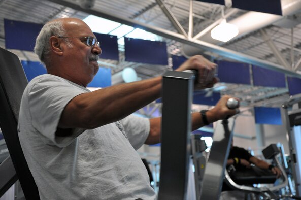 Dan Curtright, a 21-year retired veteran, uses an exercise machine at Freedom Hall Fitness Center Oct. 30. Curtright was at Freedom Hall as part of his weekly aerobic and weight lifting routine which he says helps him do the things he enjoys in life. (U.S. Air Force photo by Senior Airman Dan Gage)