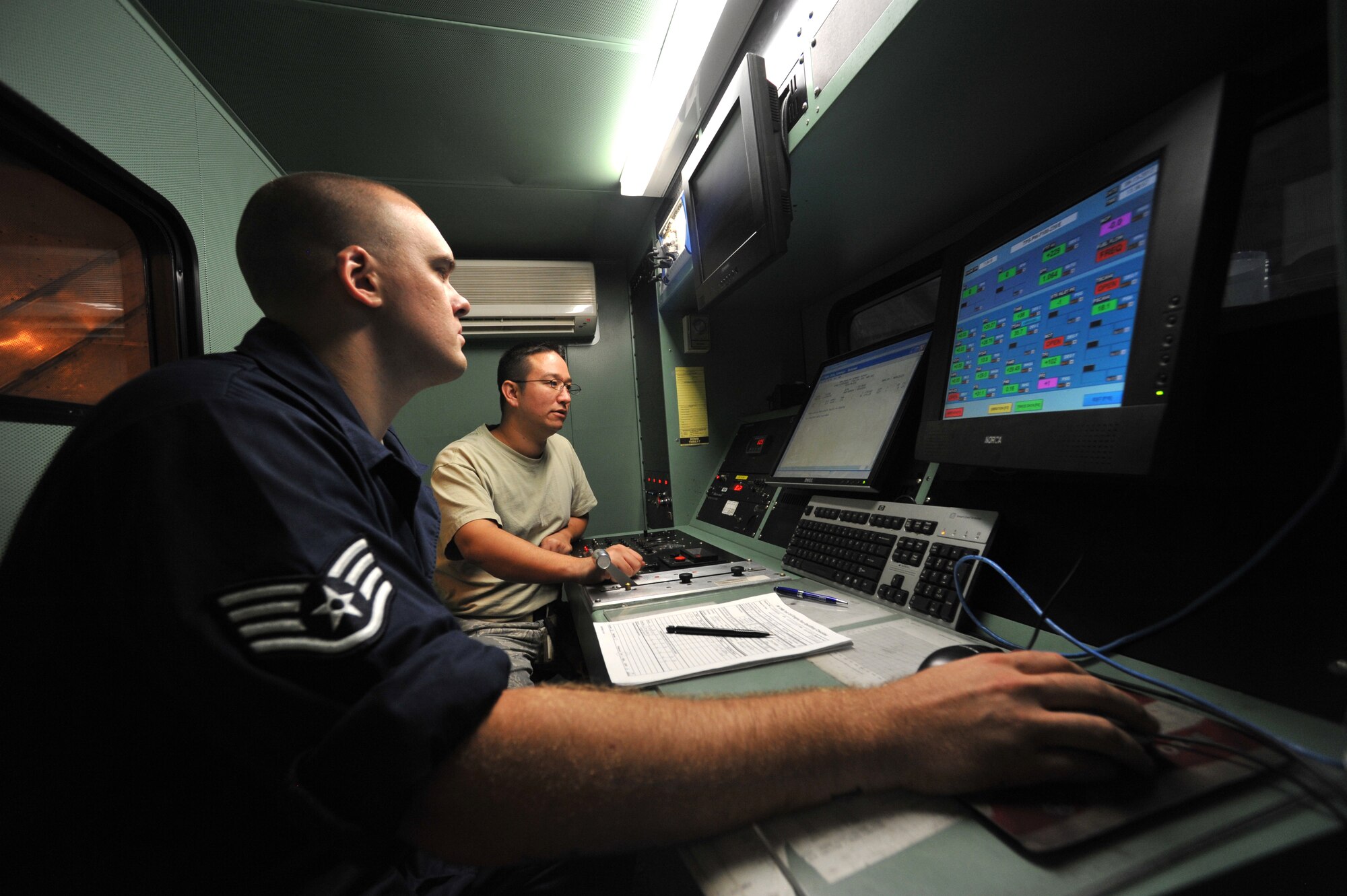 Staff Sgts. Matthew Price and Nathan Varnagates, 56th Component Maintenance Squadron test cell technicians, review an engine download after running it in full afterburner at hush house two. There are three hush houses at Luke AFB, two of which are for uninstalled engine runs and one is used after quiet hours for installed engine runs. (U.S. Air Force photo by Senior Airman Sandra Welch)
